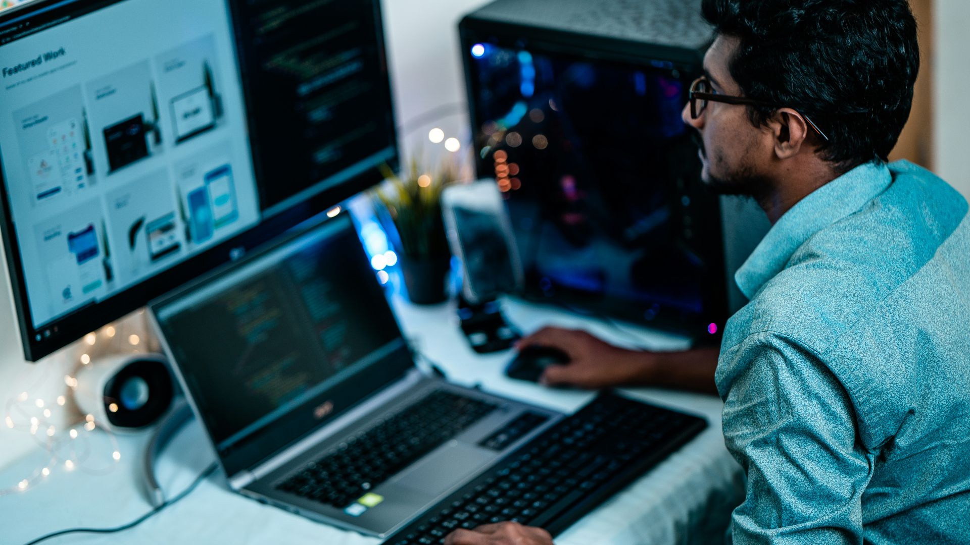 man in blue dress shirt using computer