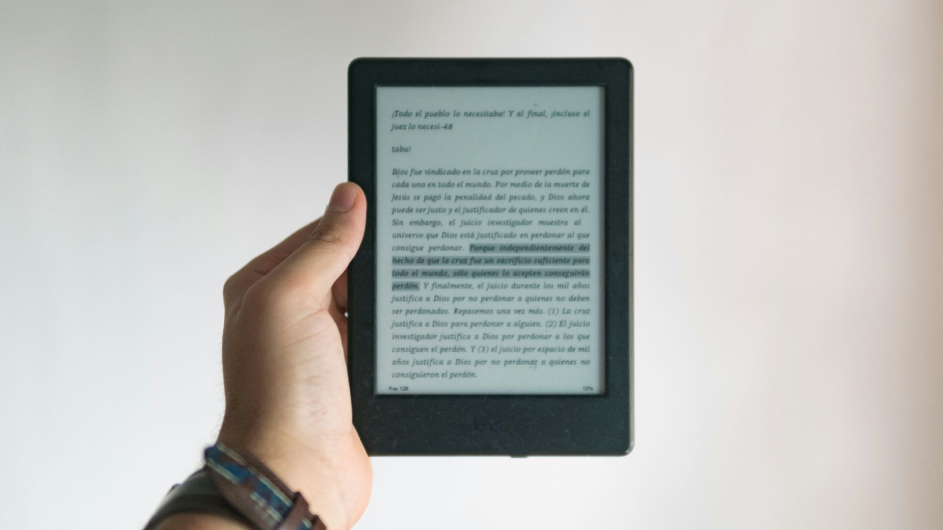 person holding black e book reader