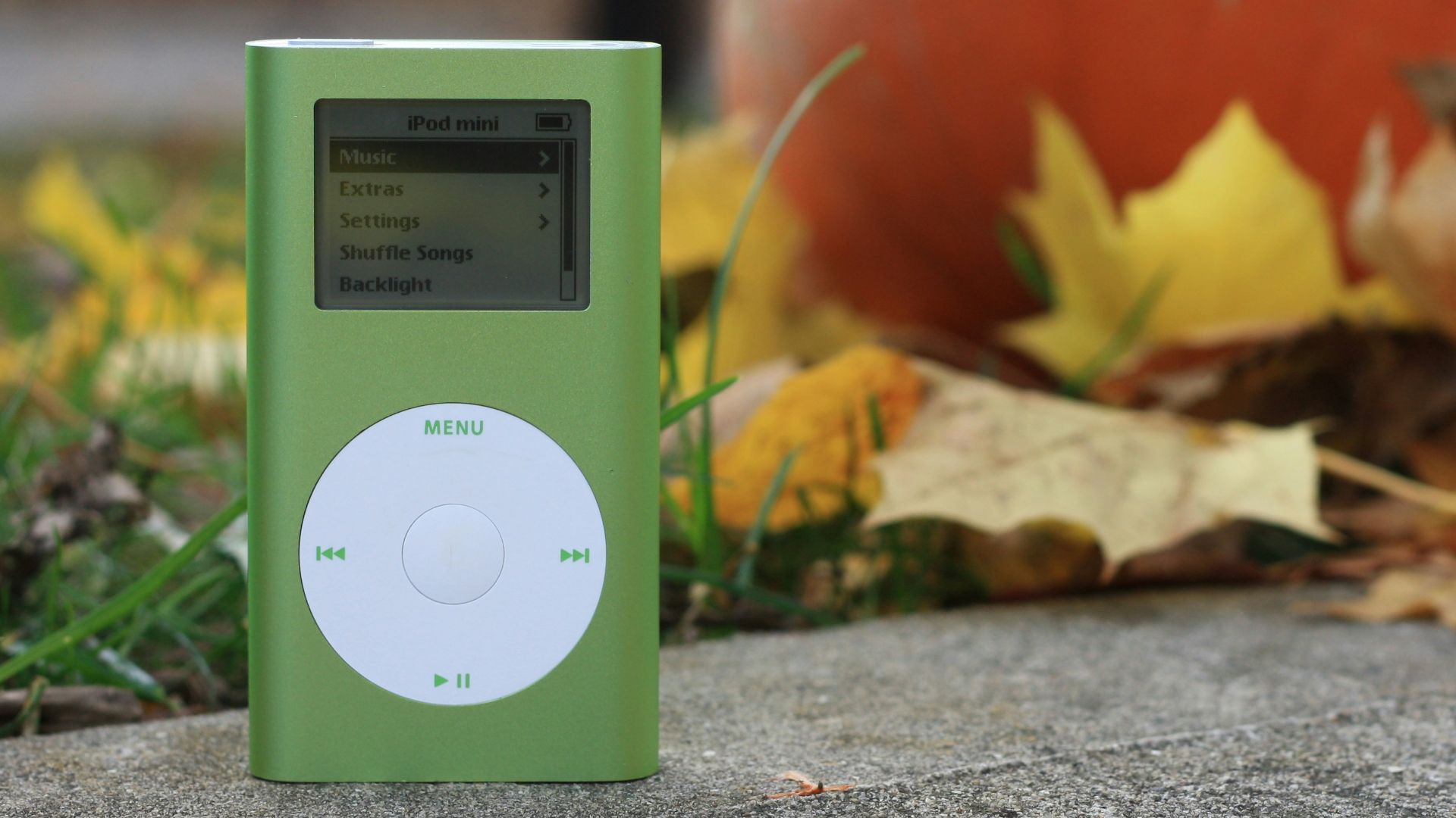 white ipod nano 4 th generation on gray concrete floor