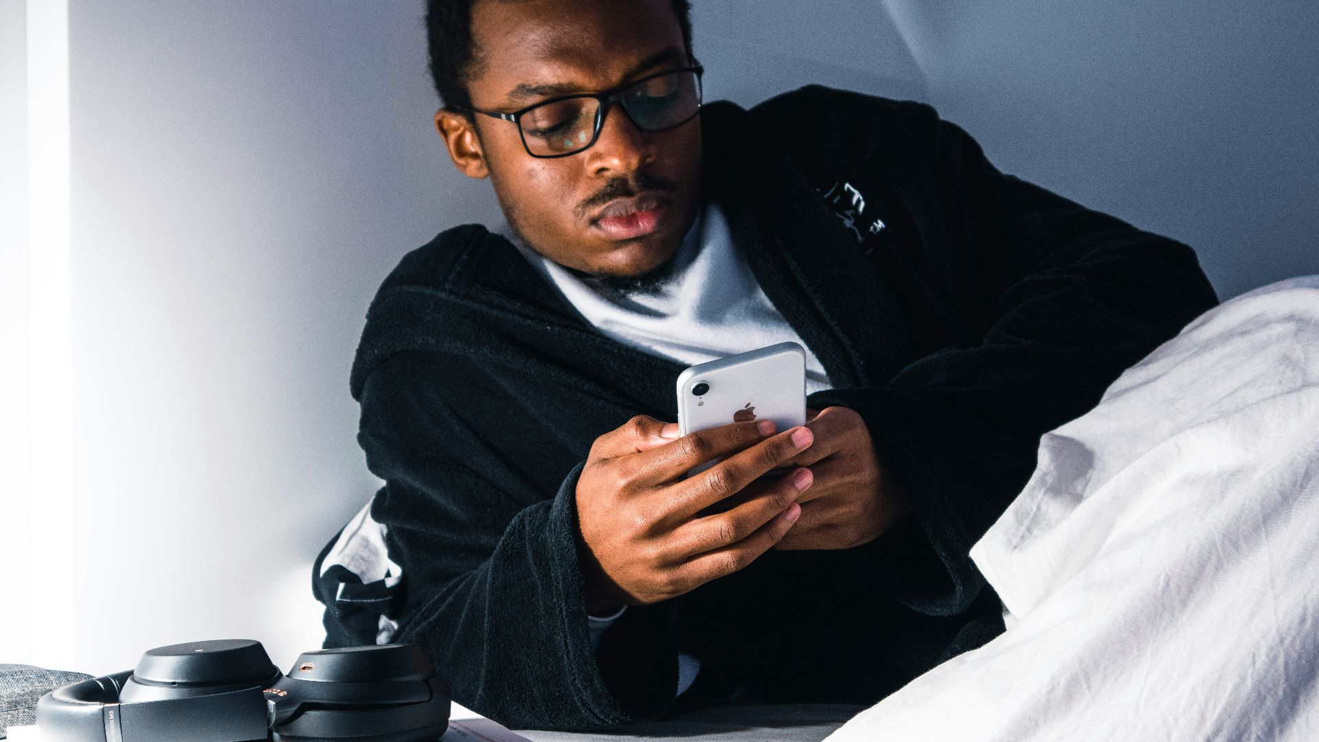 man in black jacket wearing black framed eyeglasses