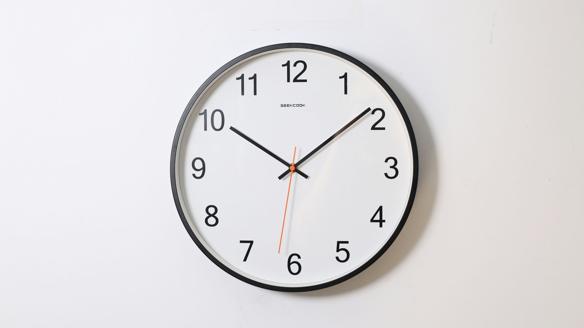round analog wall clock pointing at 10:09