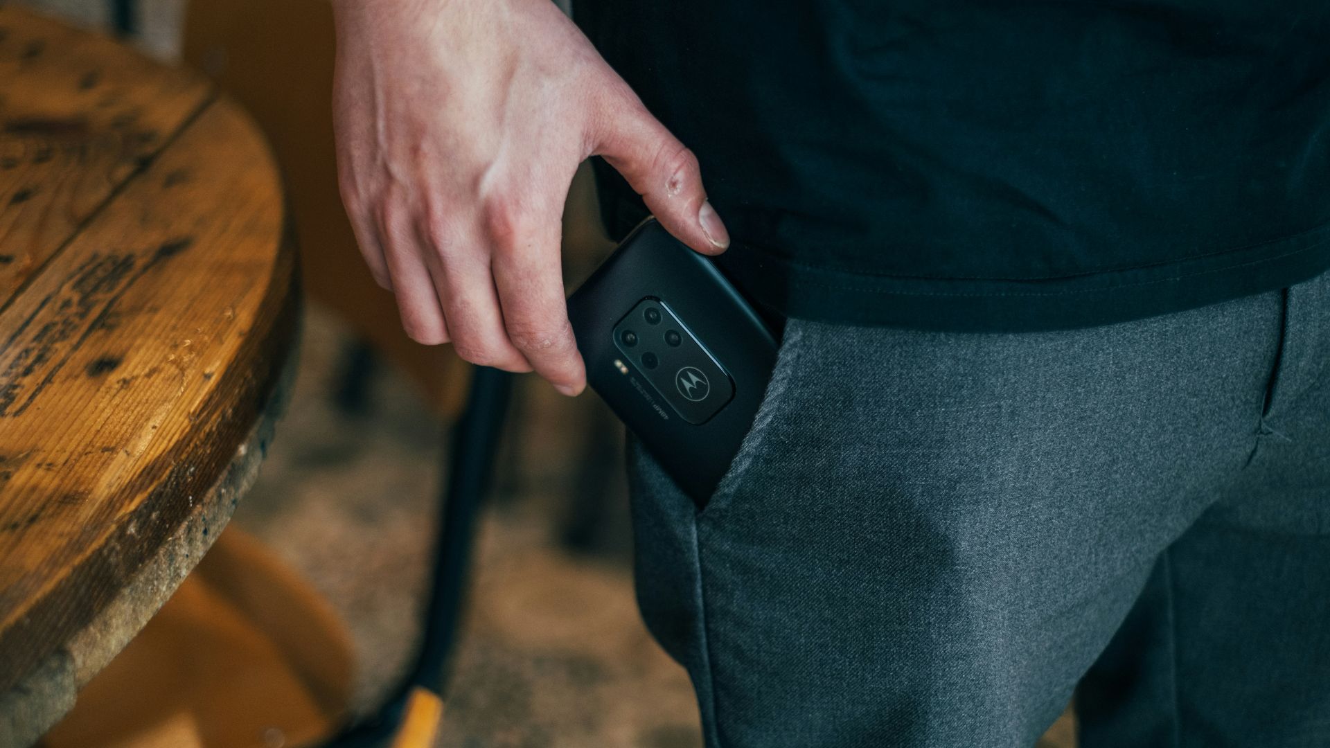 person inserting smartphone in pocket