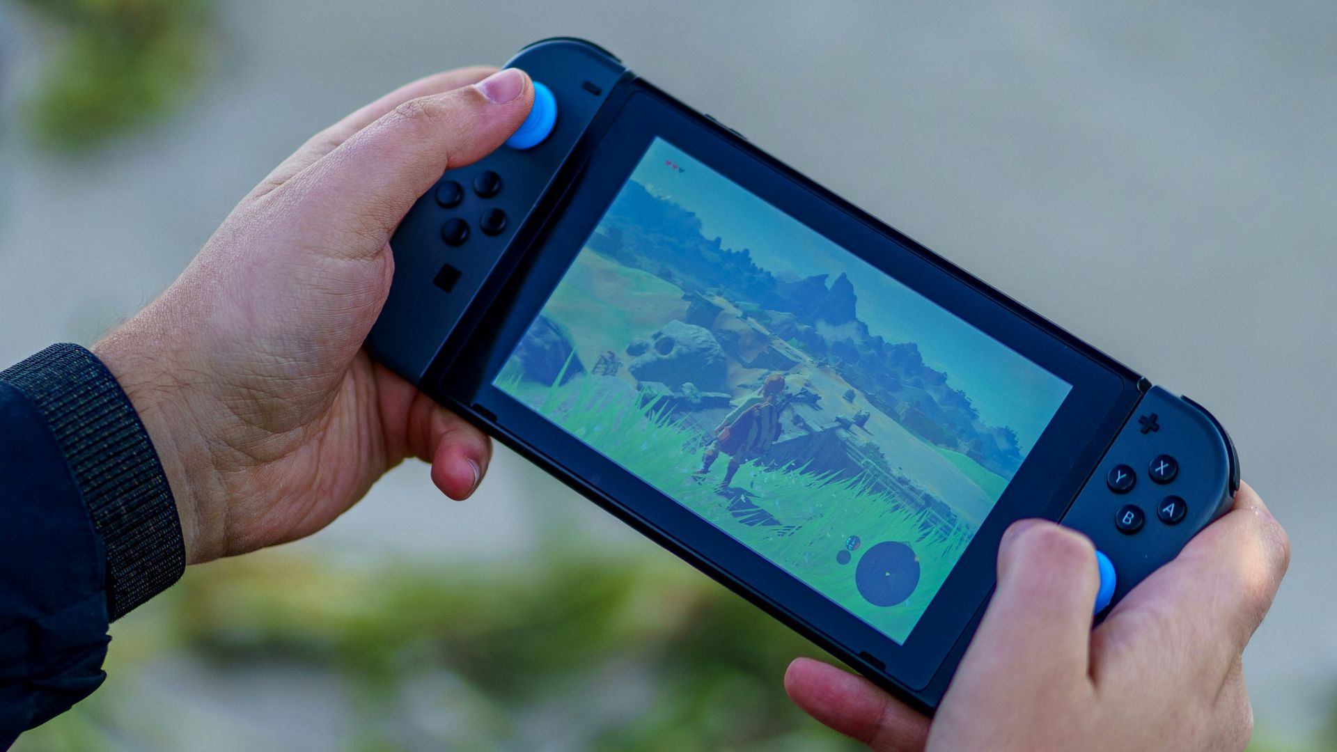 a person is playing a video game on a cell phone