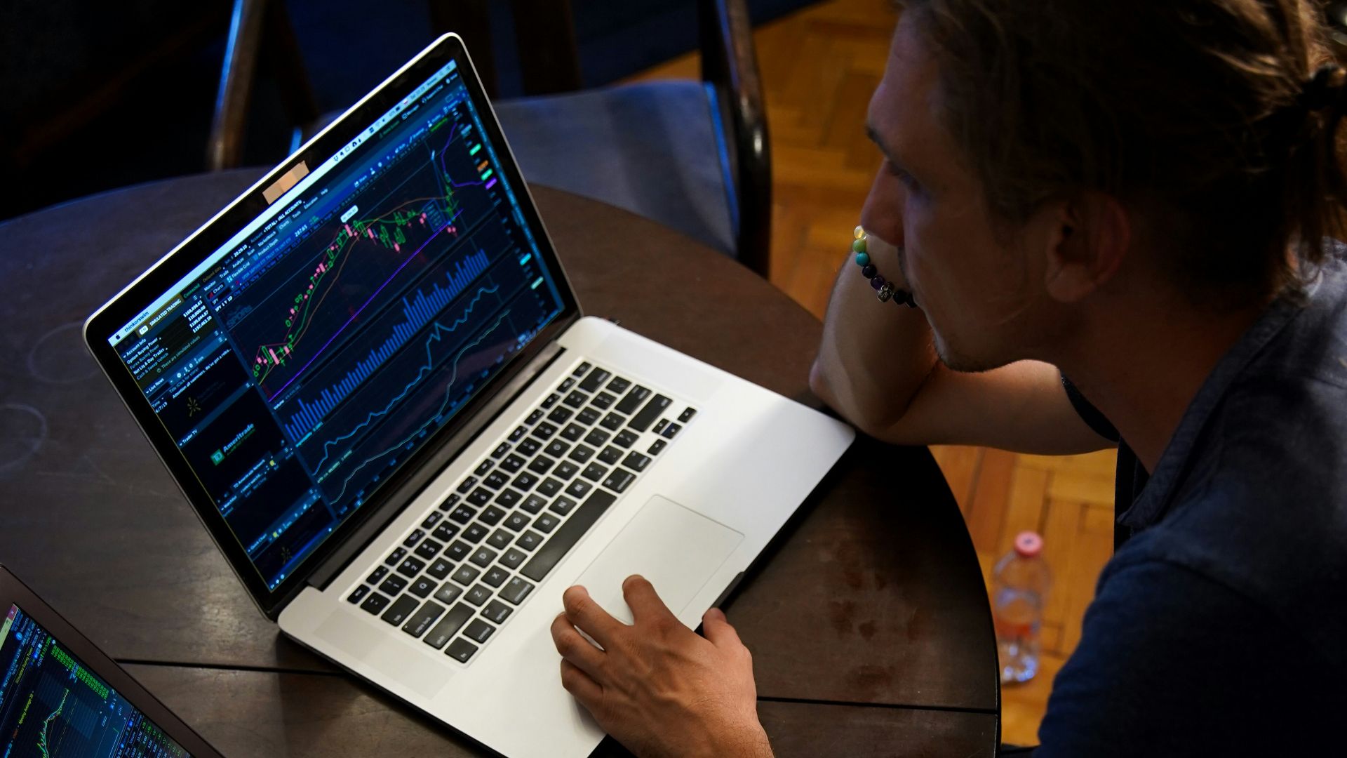man sitting in front of the MacBook Pro