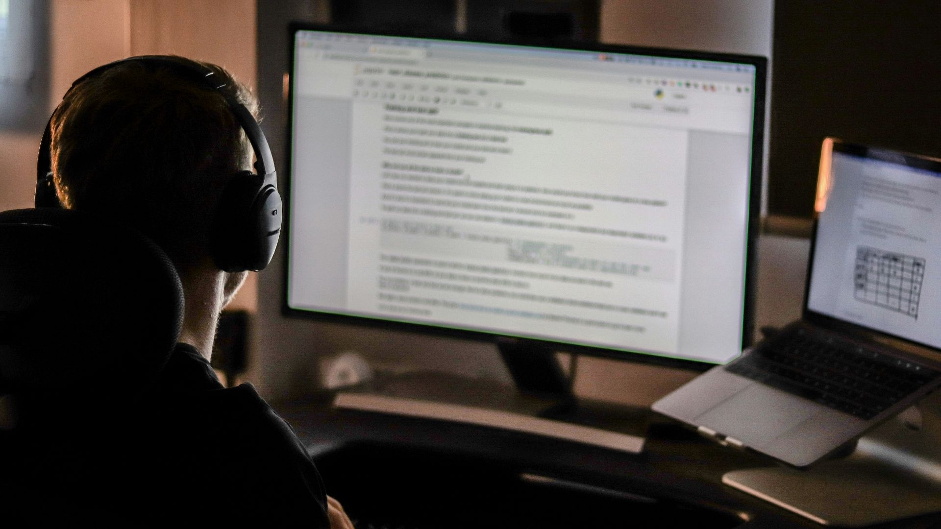 man using laptop computer and headphones