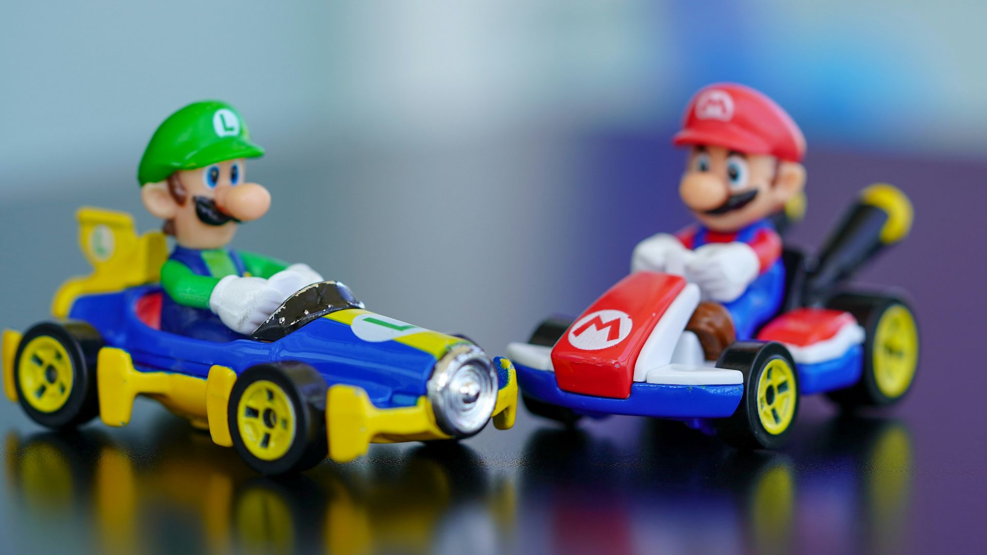 man in red helmet riding orange and blue f 1 car toy