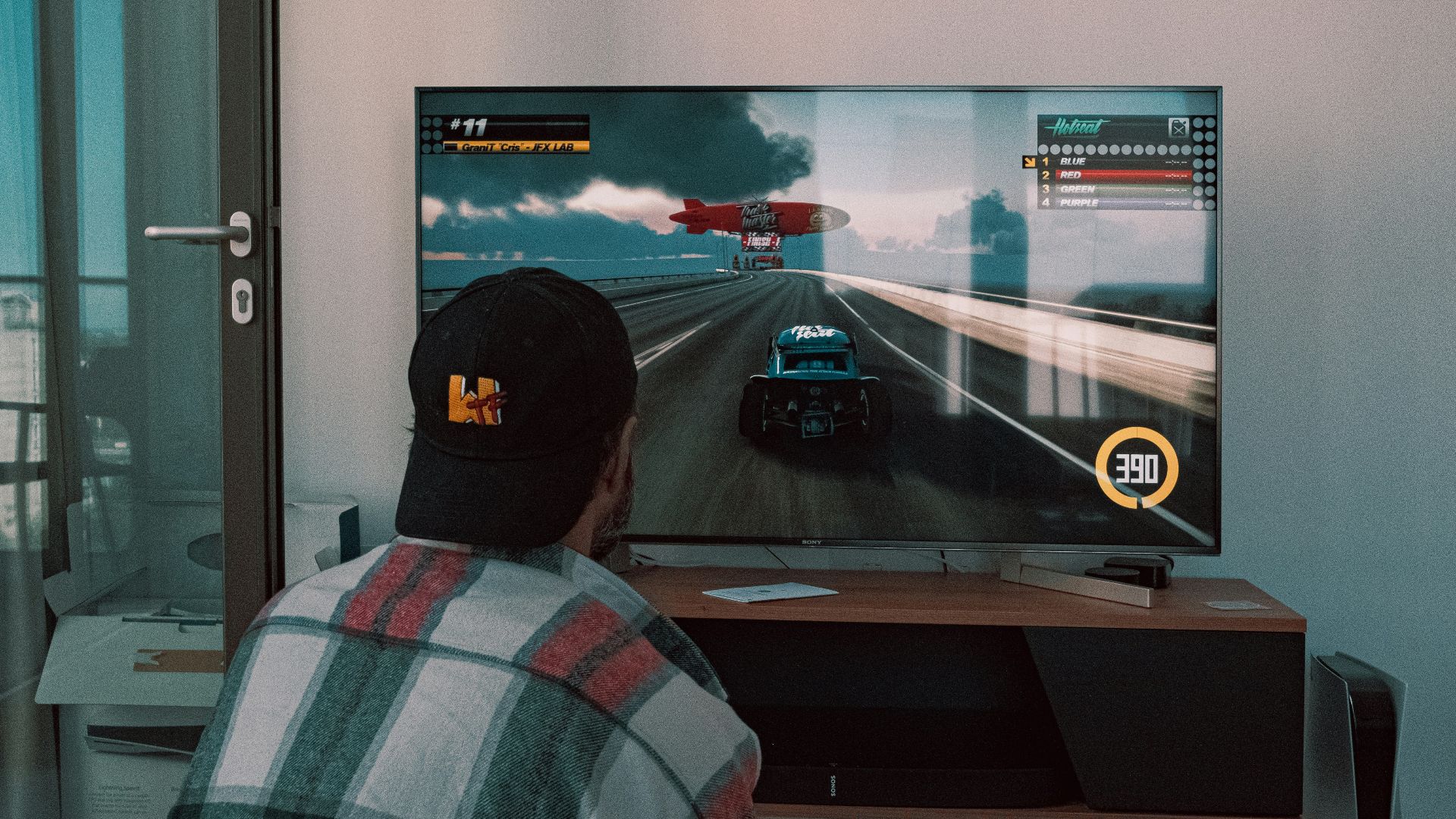 black flat screen tv turned on near white wall