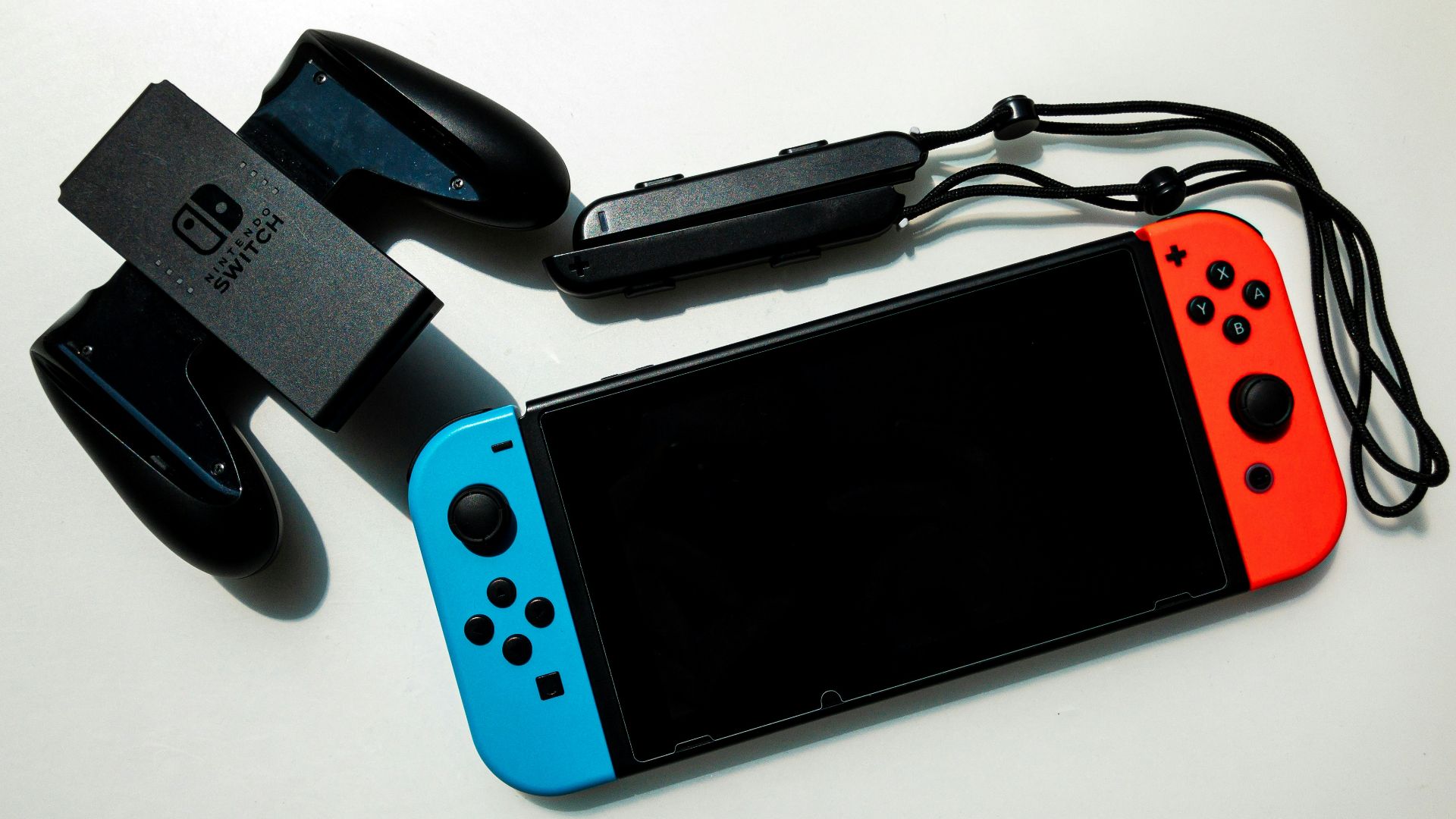 white nintendo switch beside black usb flash drive