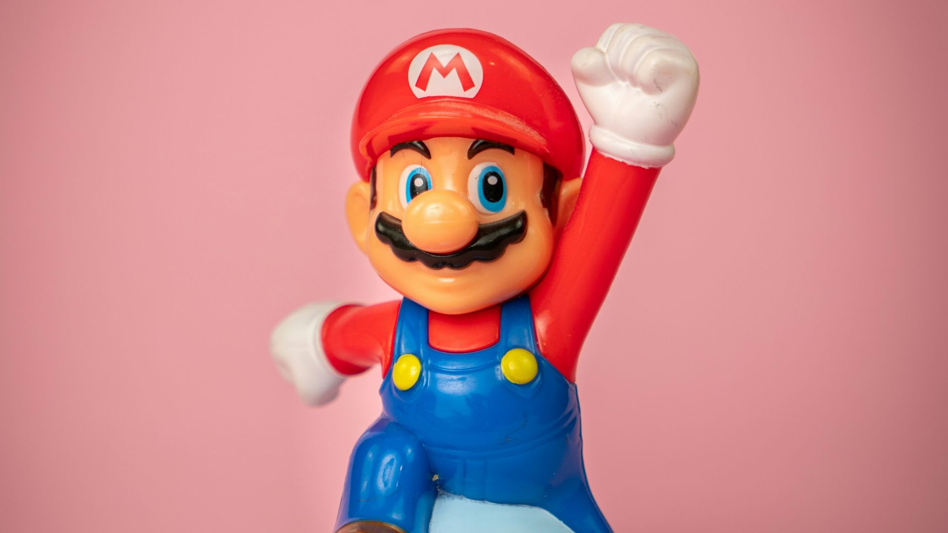 a toy figure of mario on top of a blue object