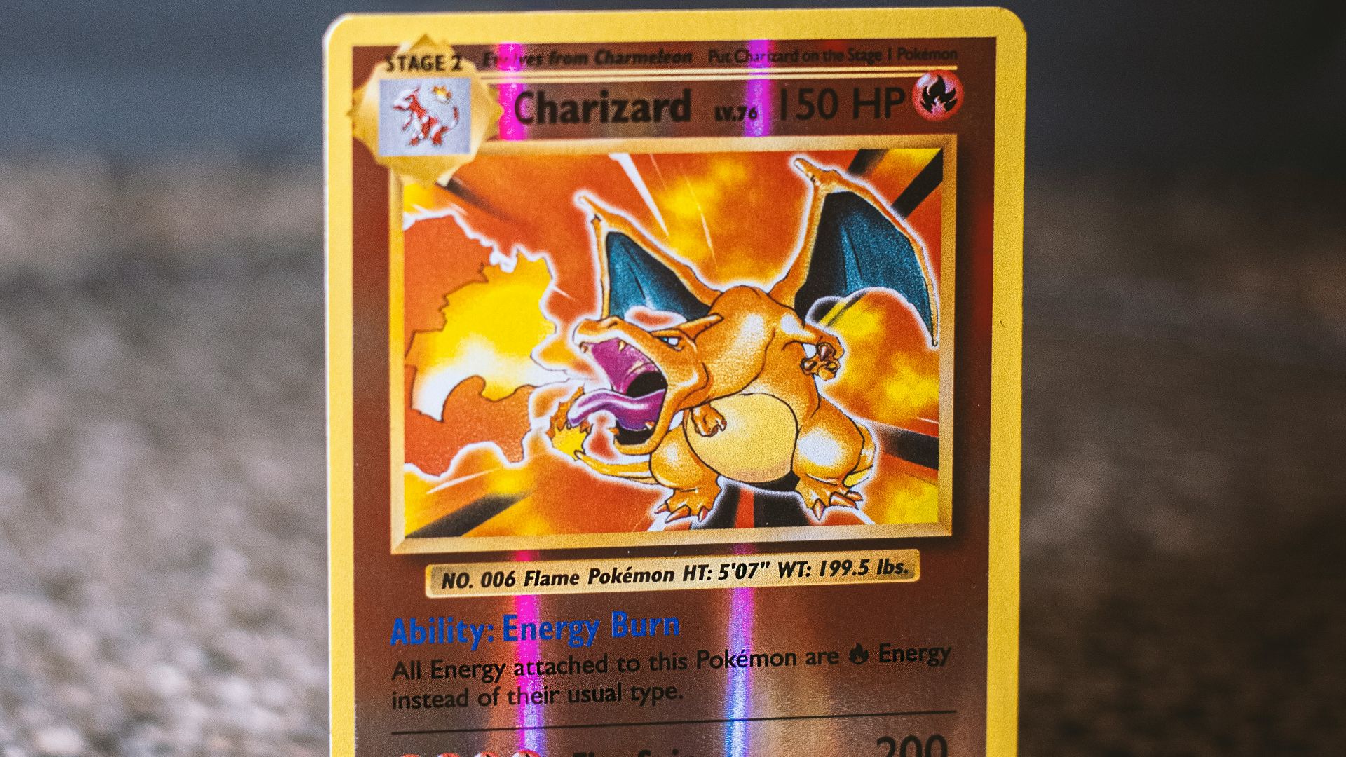 pokemon trading card on gray textile