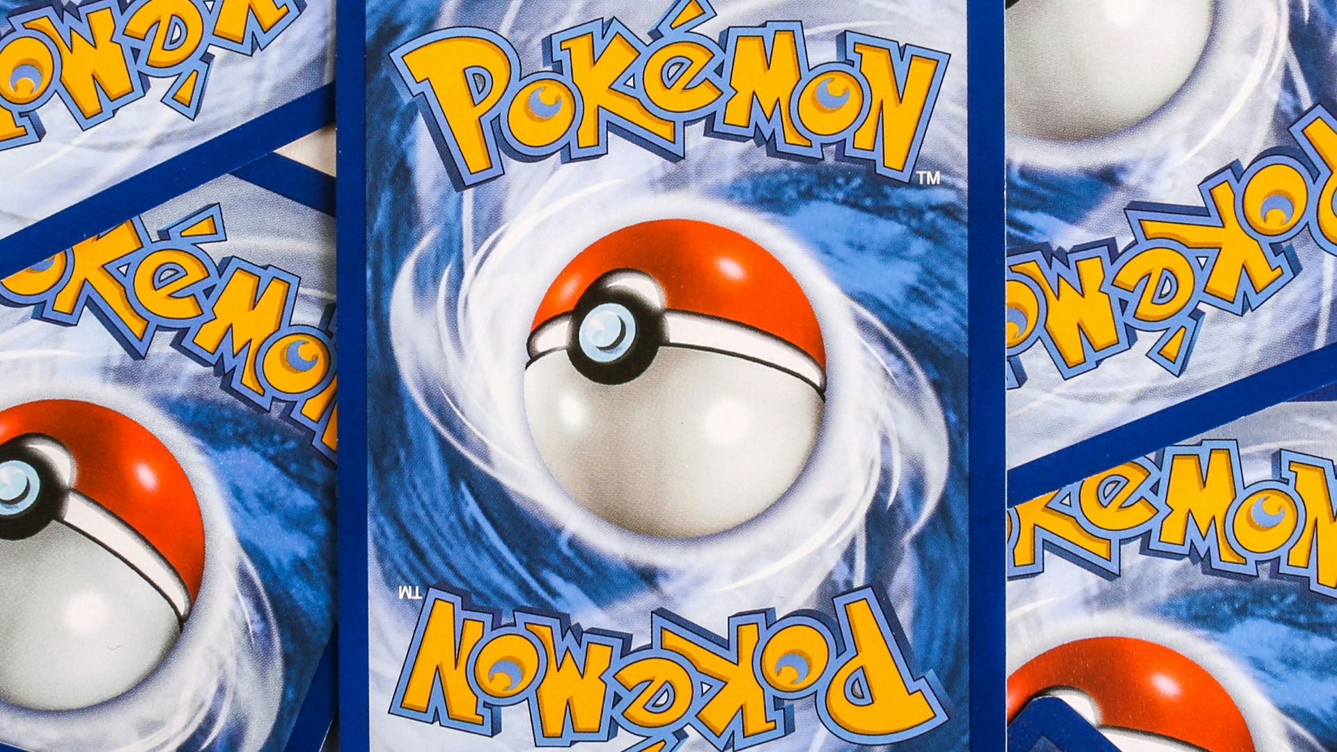 a pile of pokemon trading cards sitting on top of each other