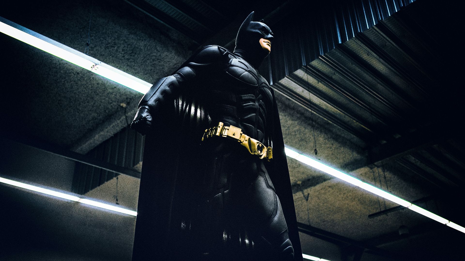Batman standing under steel roof