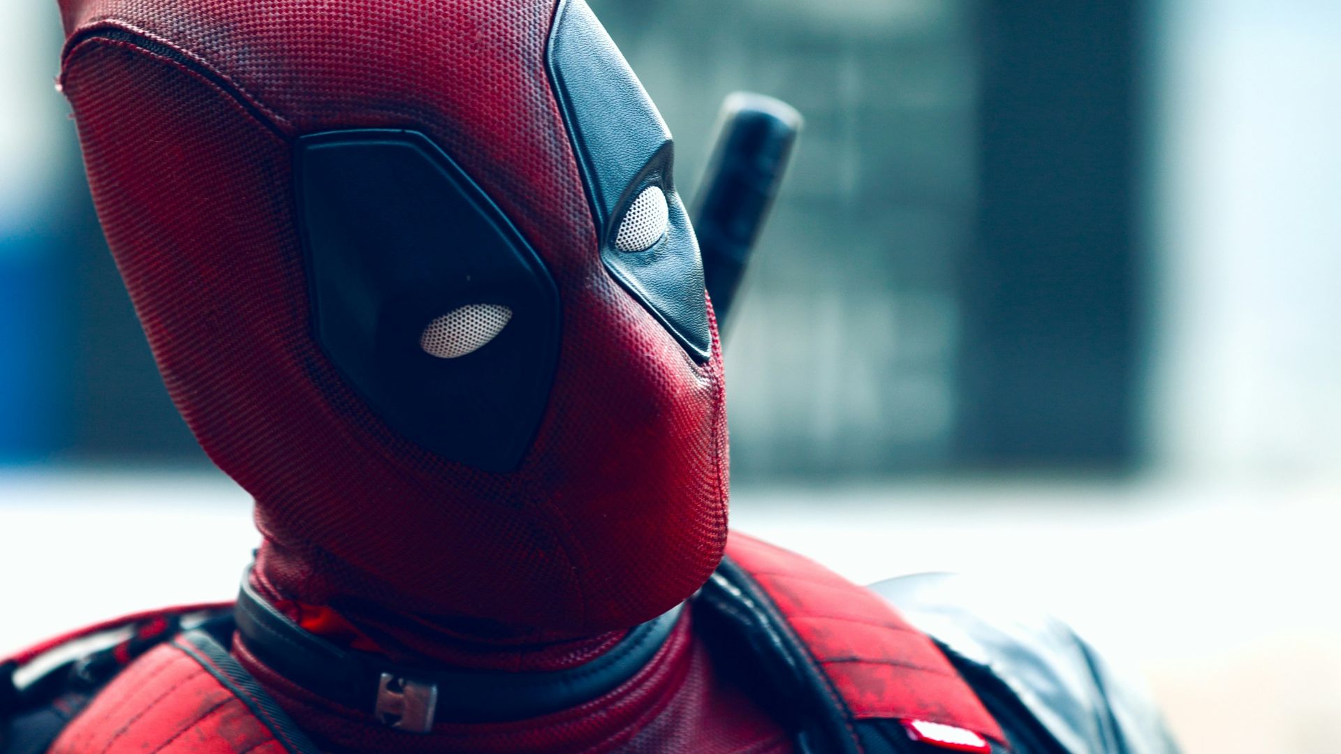 a man in a deadpool costume with a knife in his hand