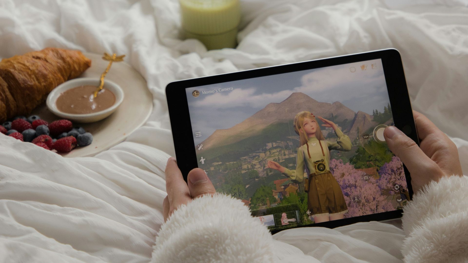 A person laying in bed holding a tablet