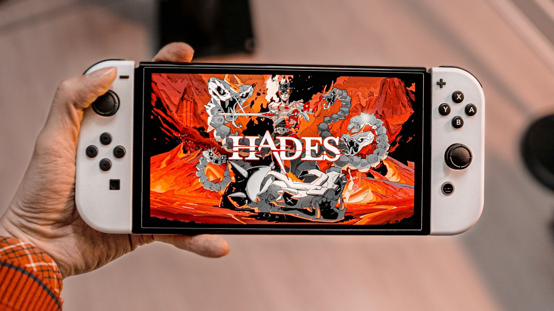 a person holding a nintendo wii game controller