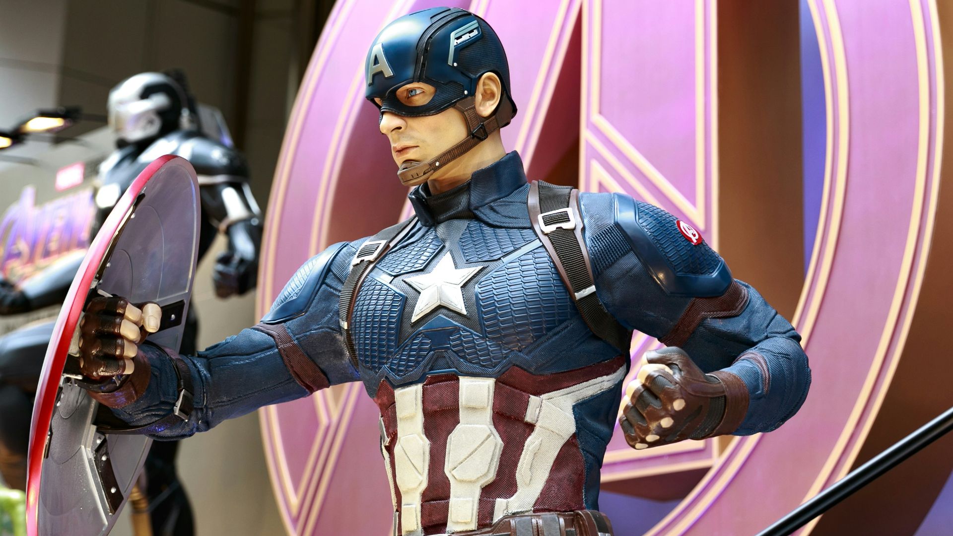 a statue of captain america holding a shield