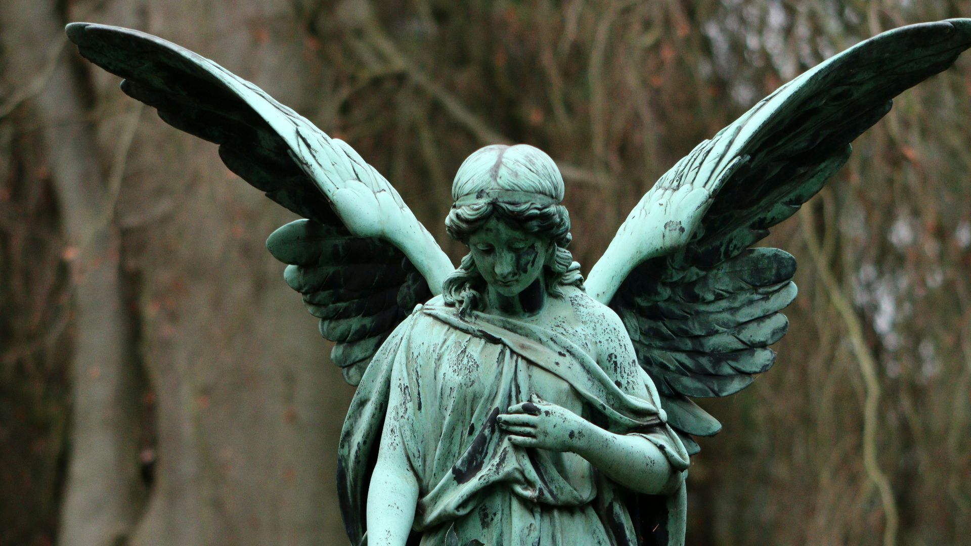 a statue of an angel holding a rose