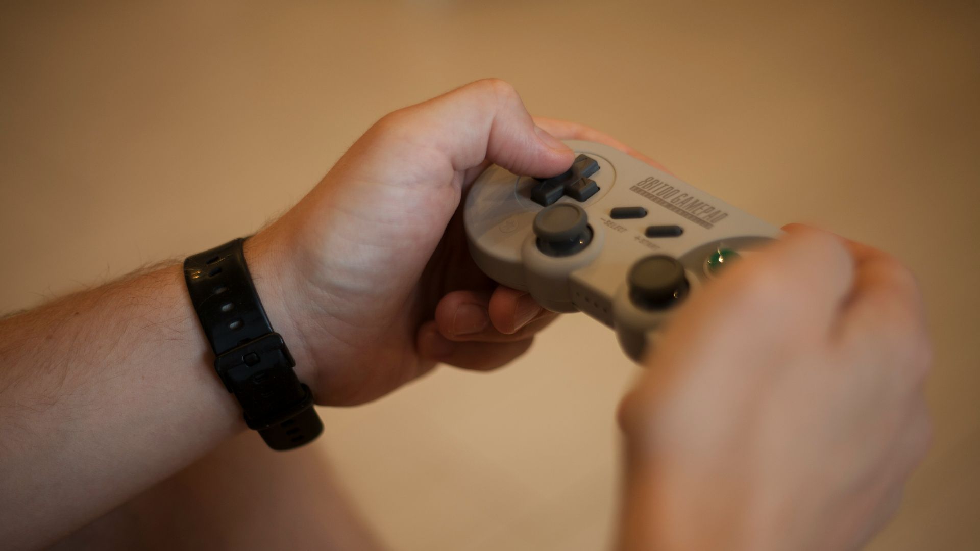 person holding white and black xbox one game controller
