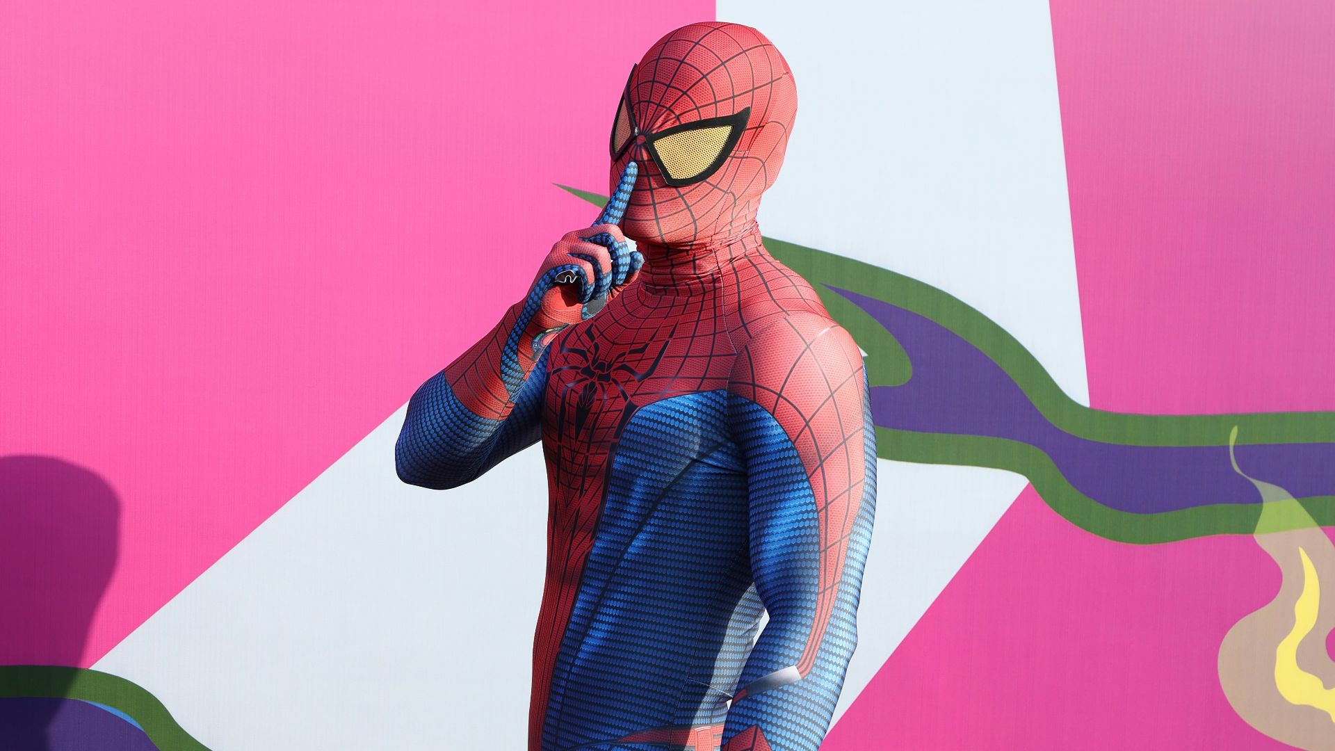 A group of men standing next to each other in front of a wall