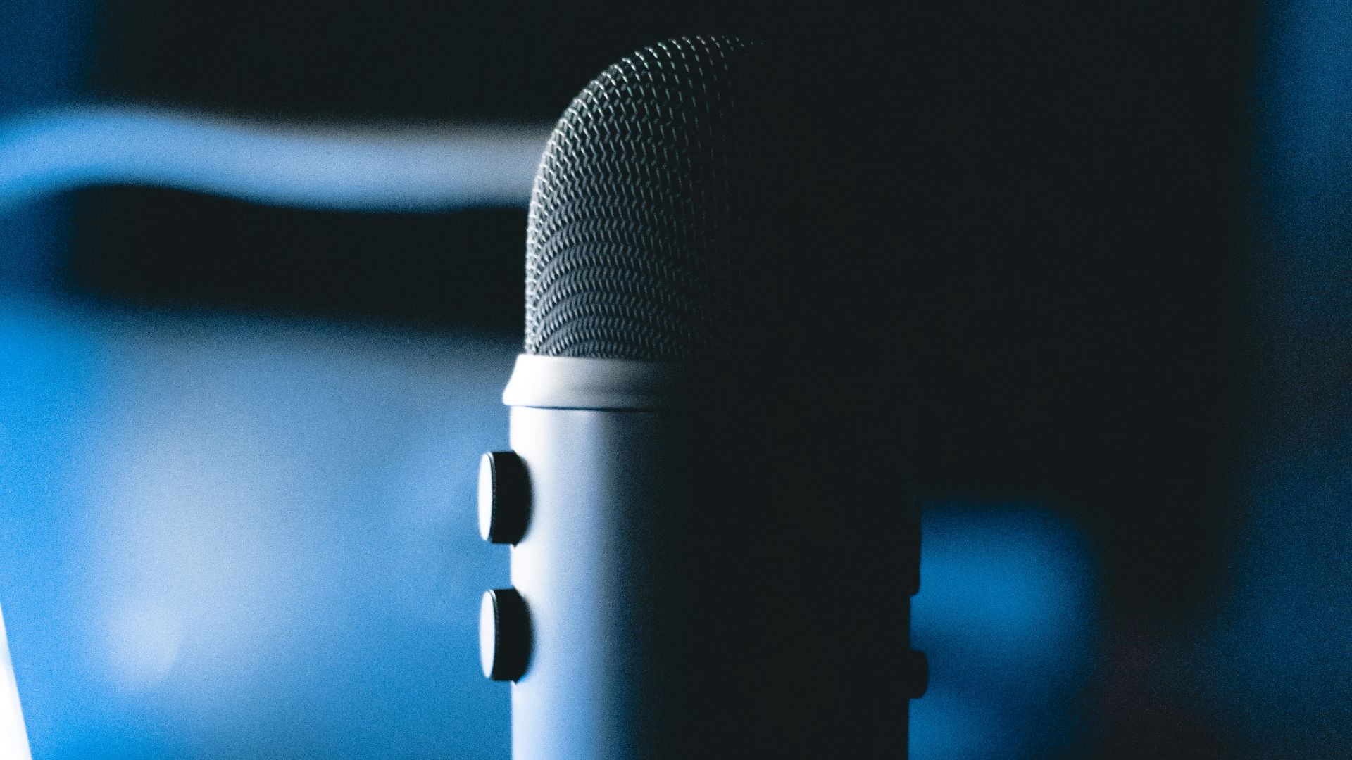 black microphone on blue and white polka dot textile