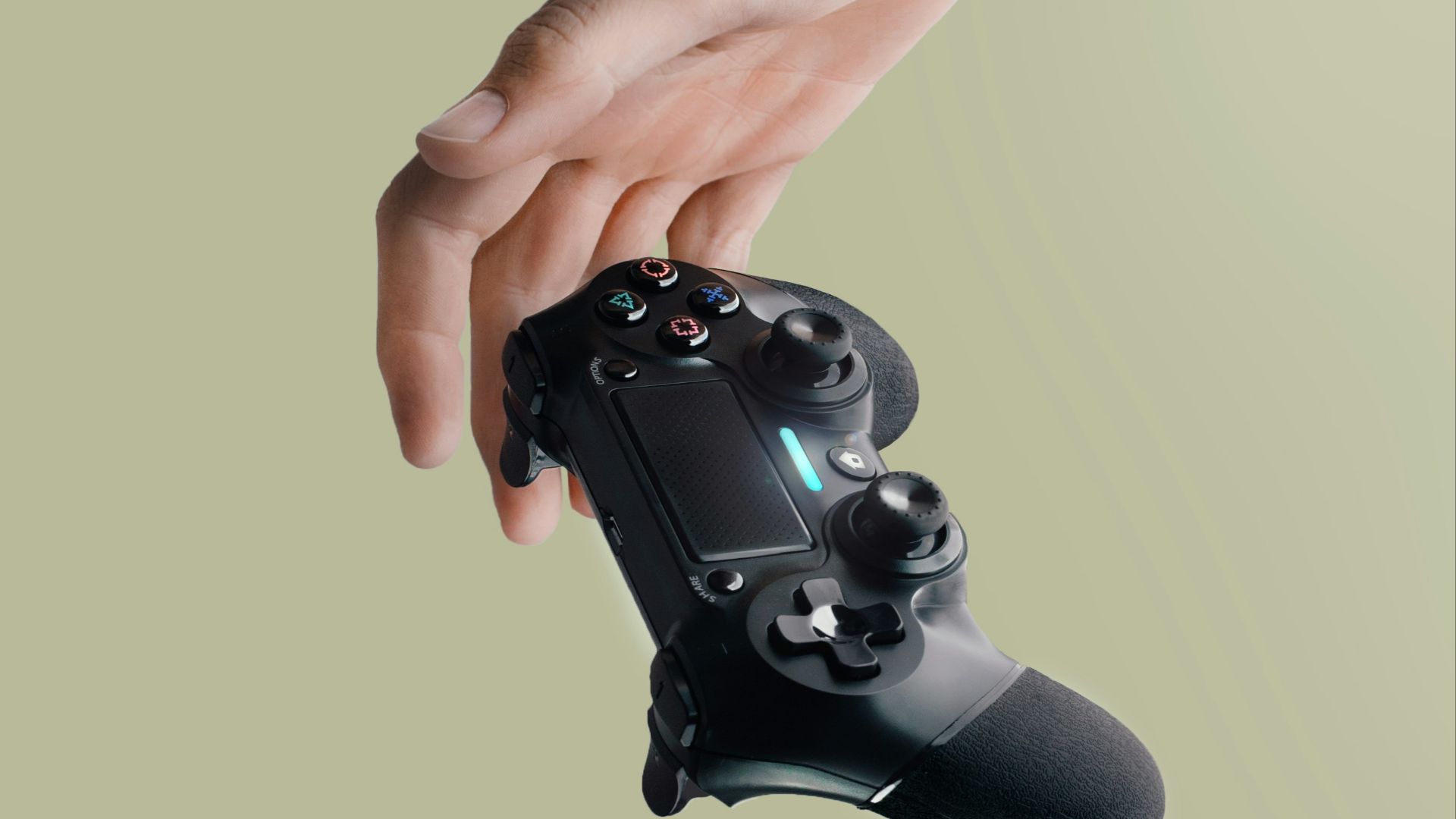 person holding Sony DualShock 4 wireless controller