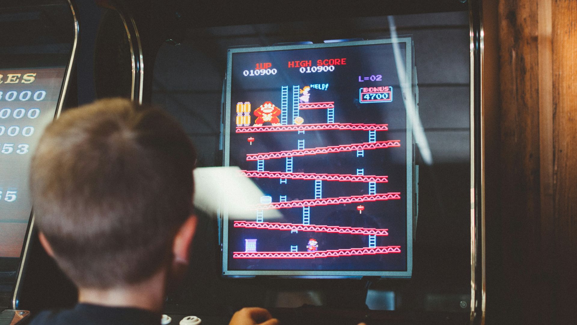 boy playing donkey kong arcade box