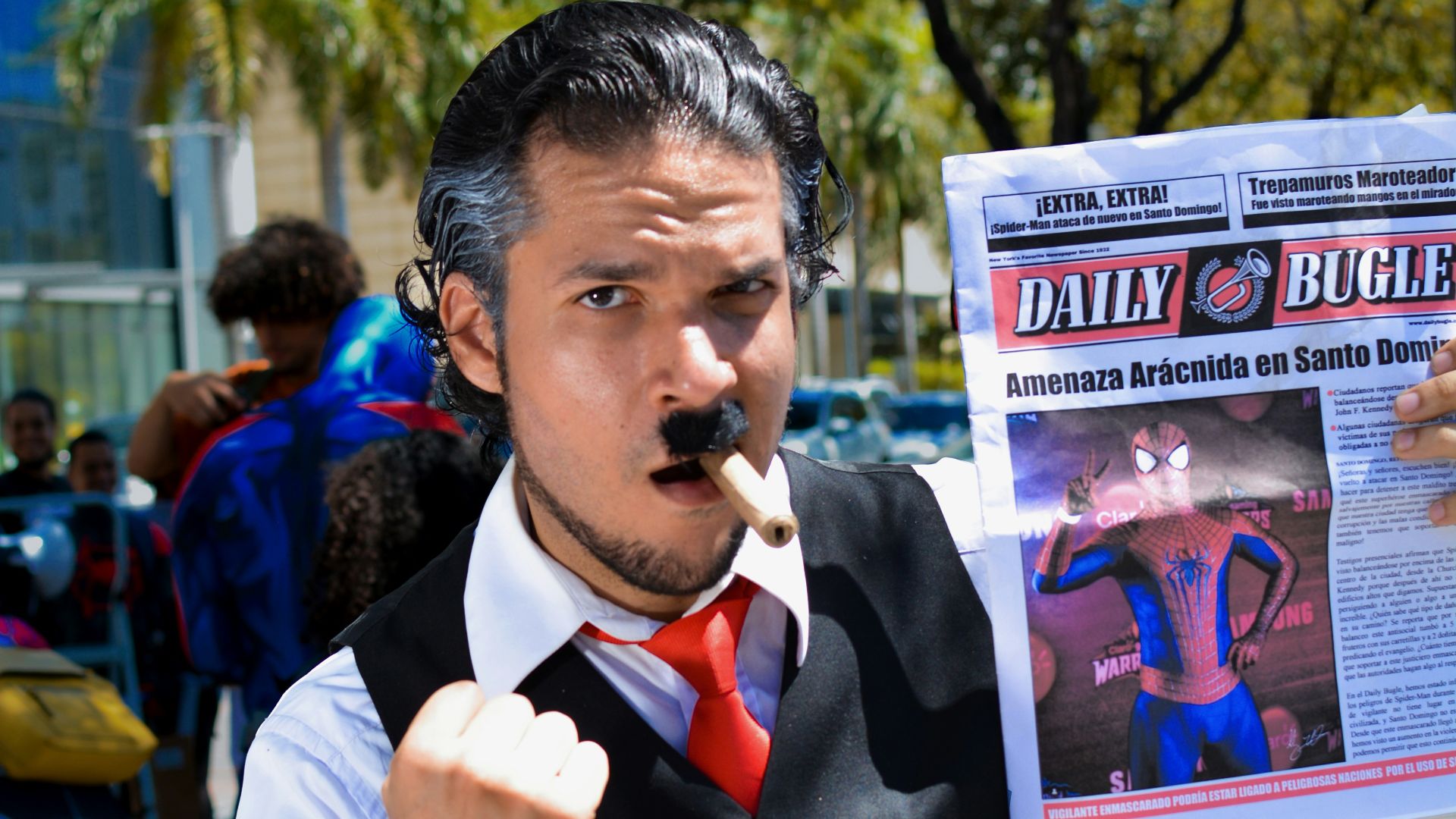 a man in a vest and tie holding a newspaper