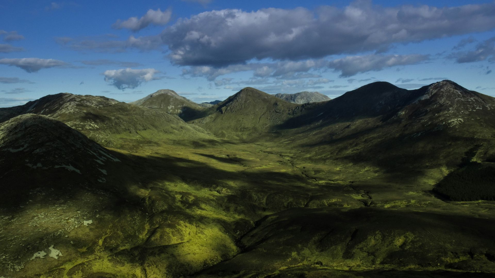 green mountain under cloudy sky