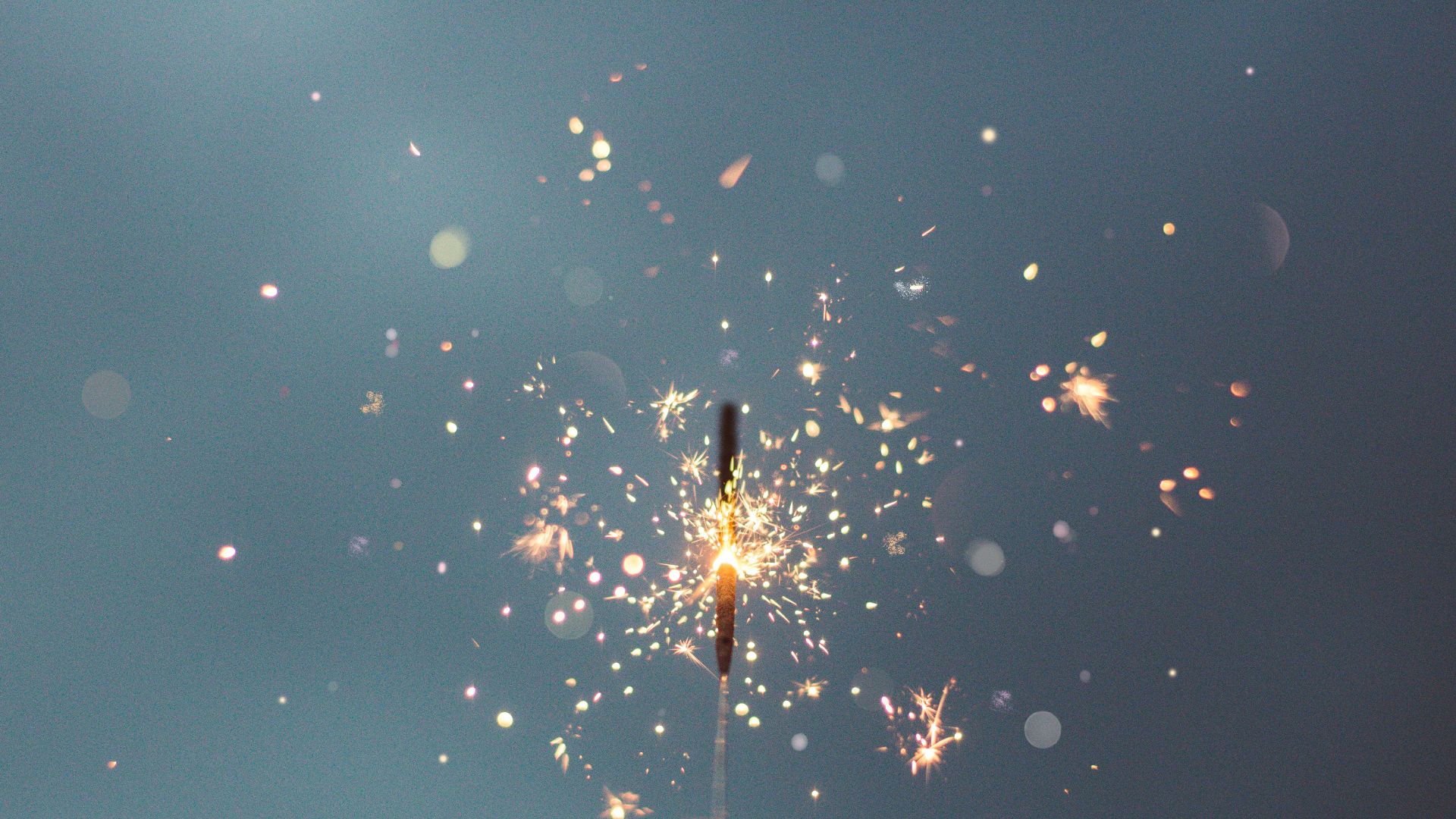 person holding lighted sparklers