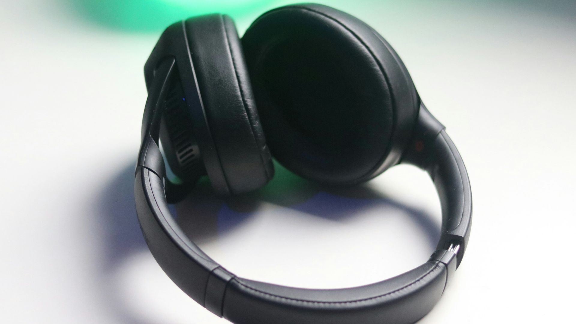 black and gray headphones on white table