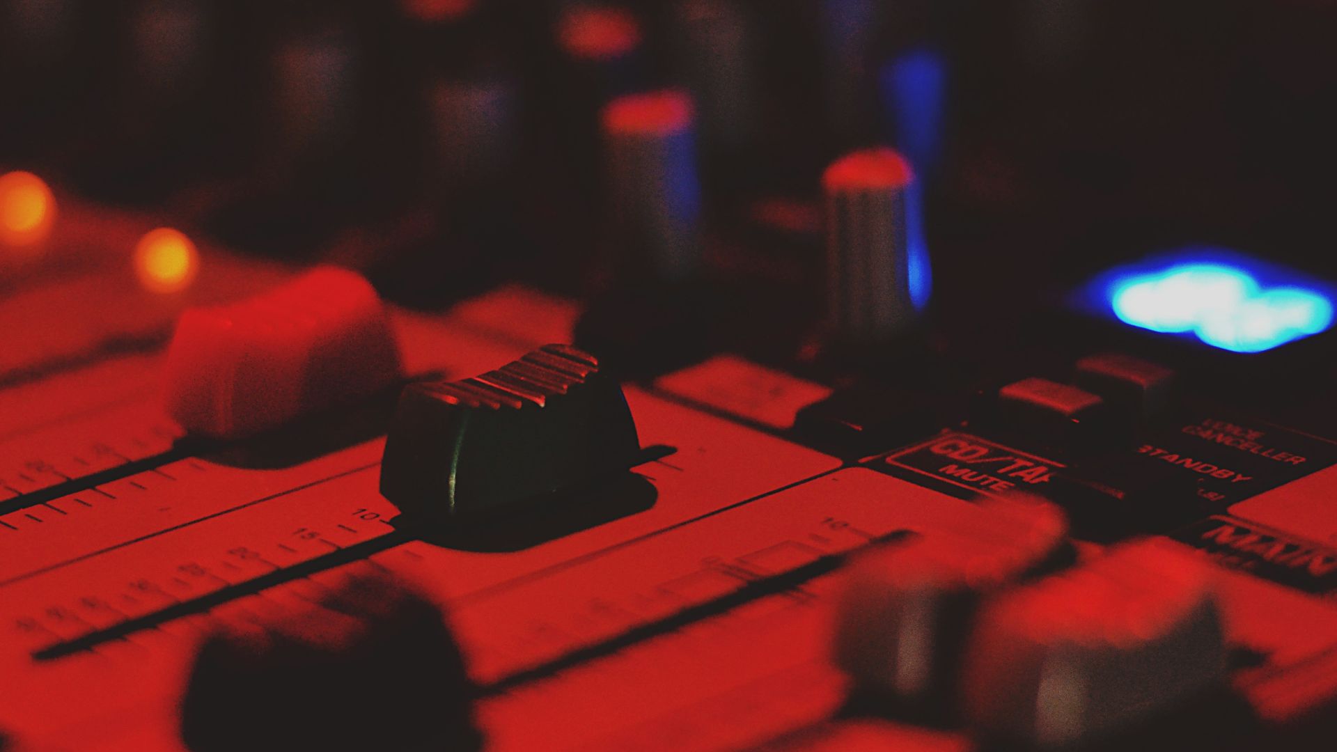 close-up photo of audio mixer with red dim light
