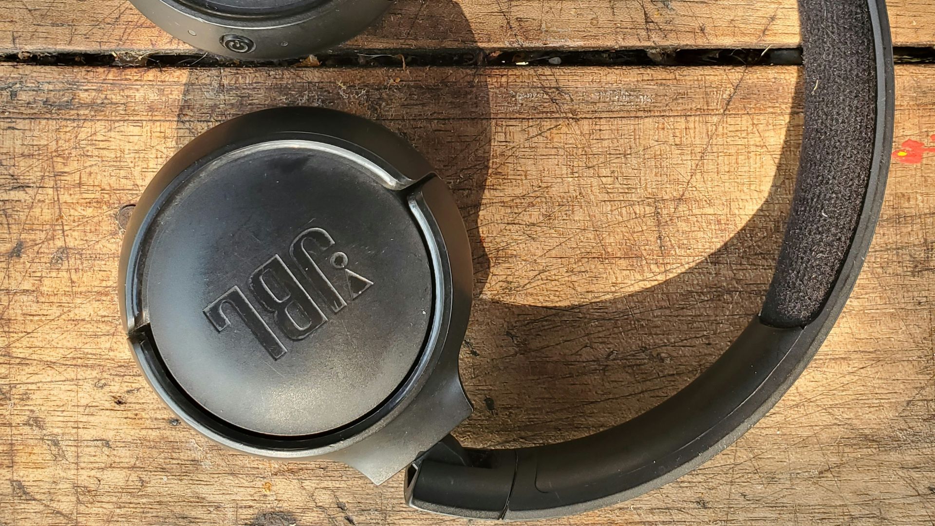 a pair of headphones sitting on top of a wooden table