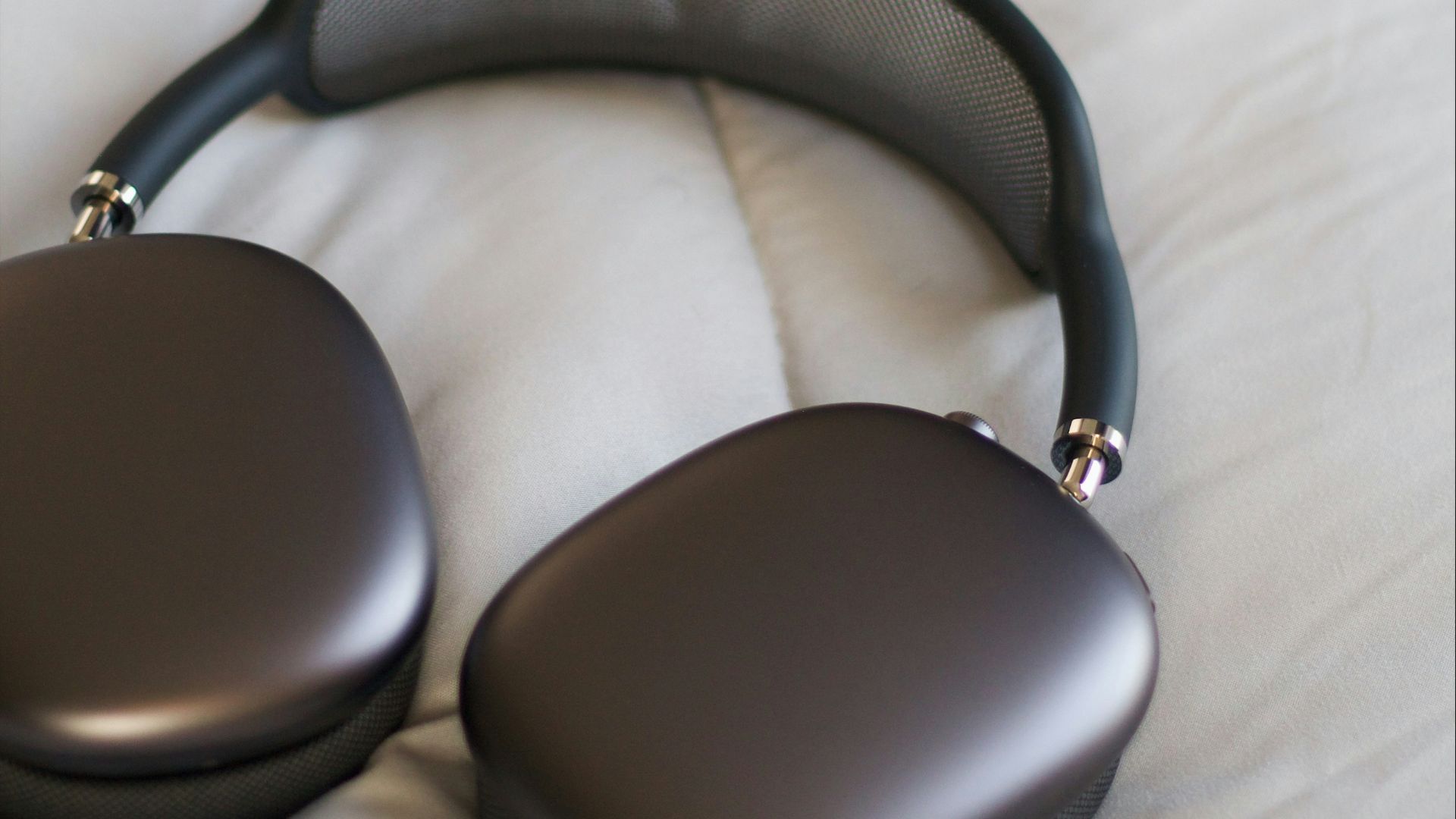 a pair of headphones sitting on top of a bed