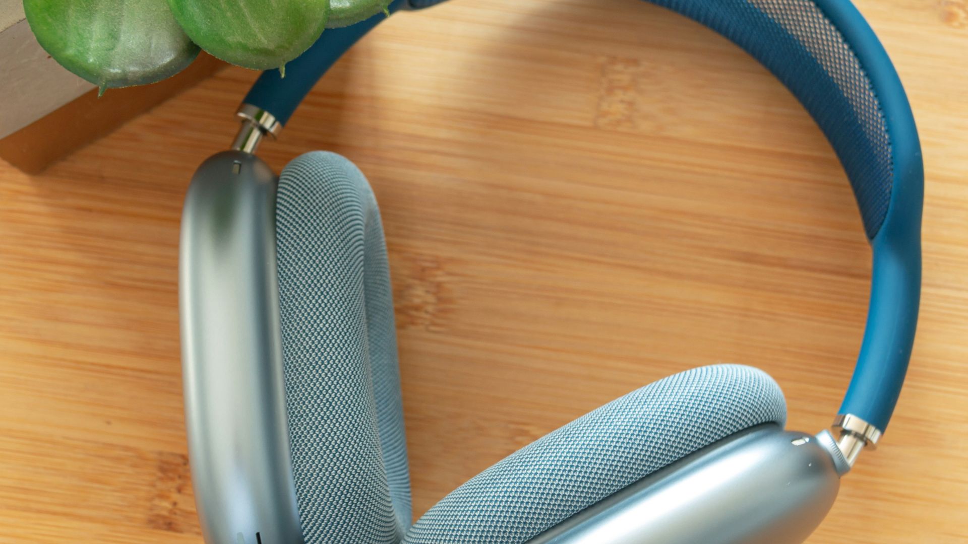 a pair of headphones sitting on top of a wooden table