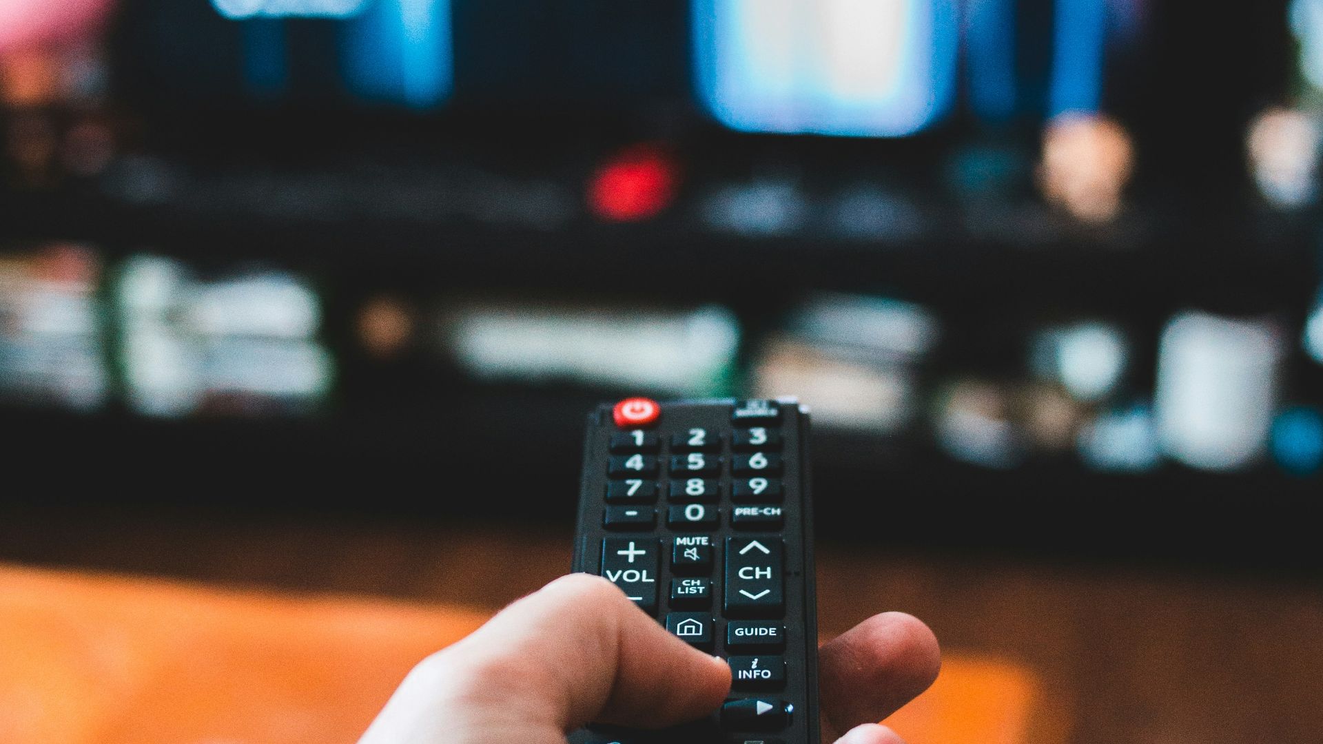 person holding black remote control