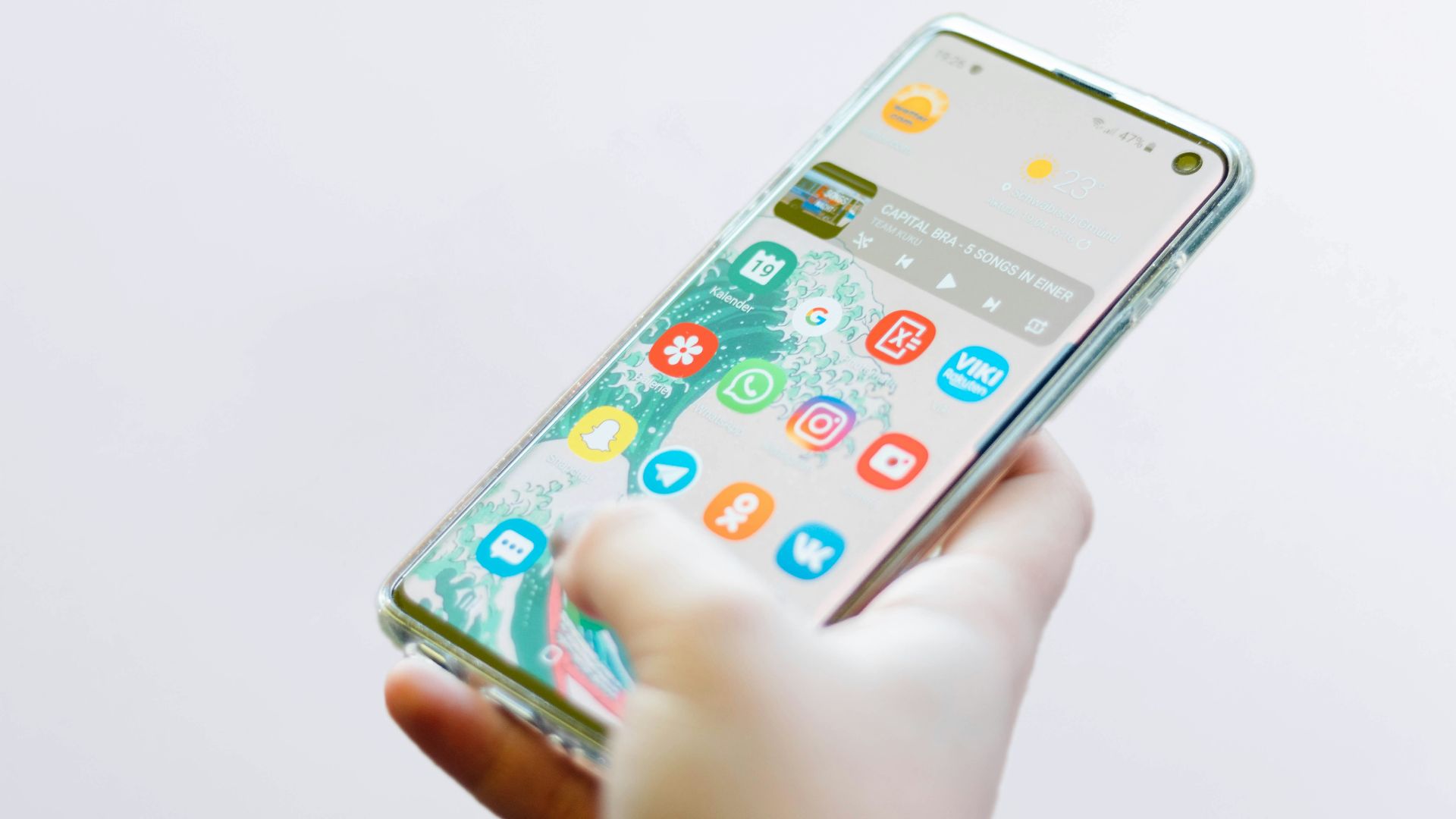 person using silver Android smartphone