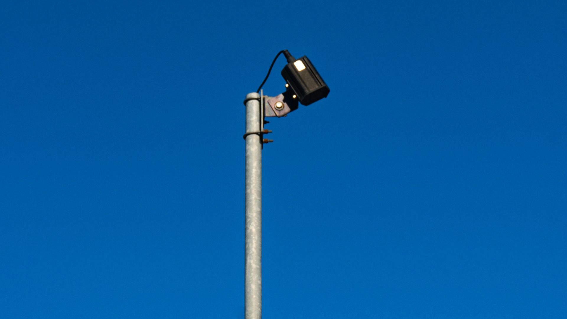 a street light with a blue sky in the background