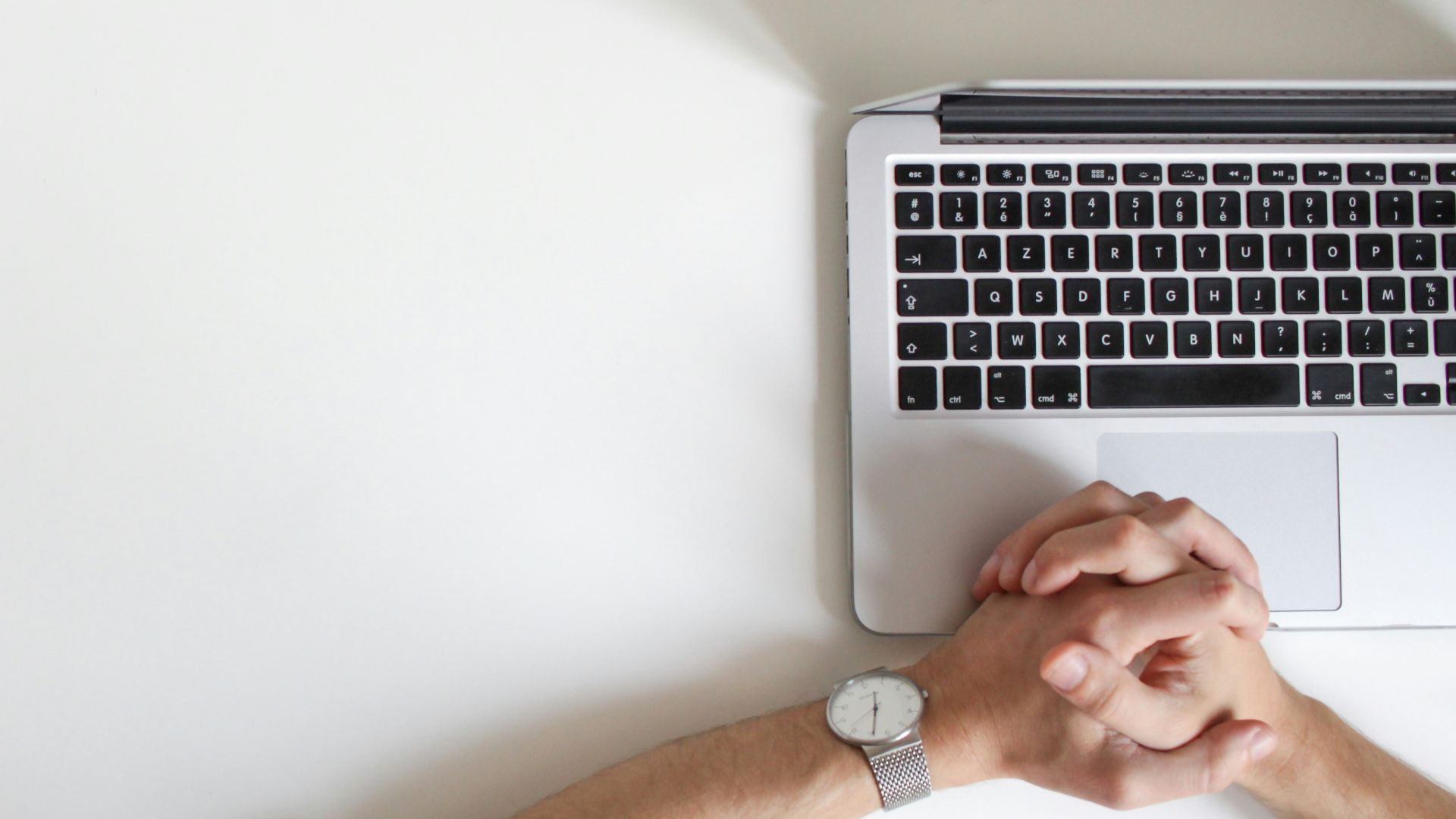 person wearing watch near laptop