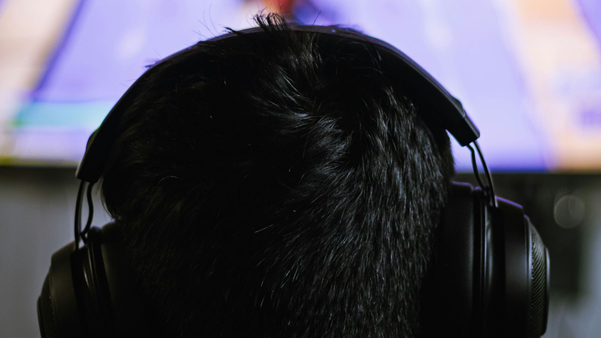 a person wearing headphones watching a television