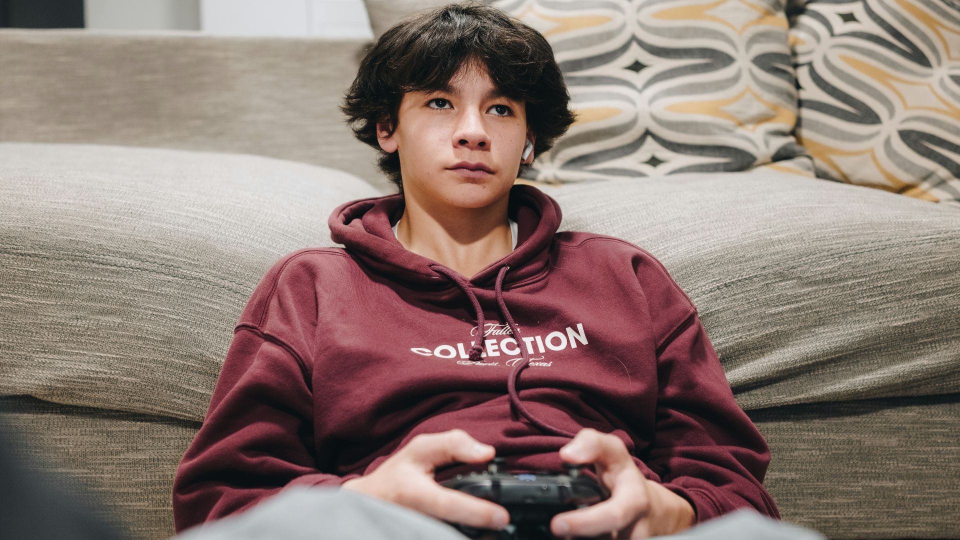 A young boy is playing a video game.