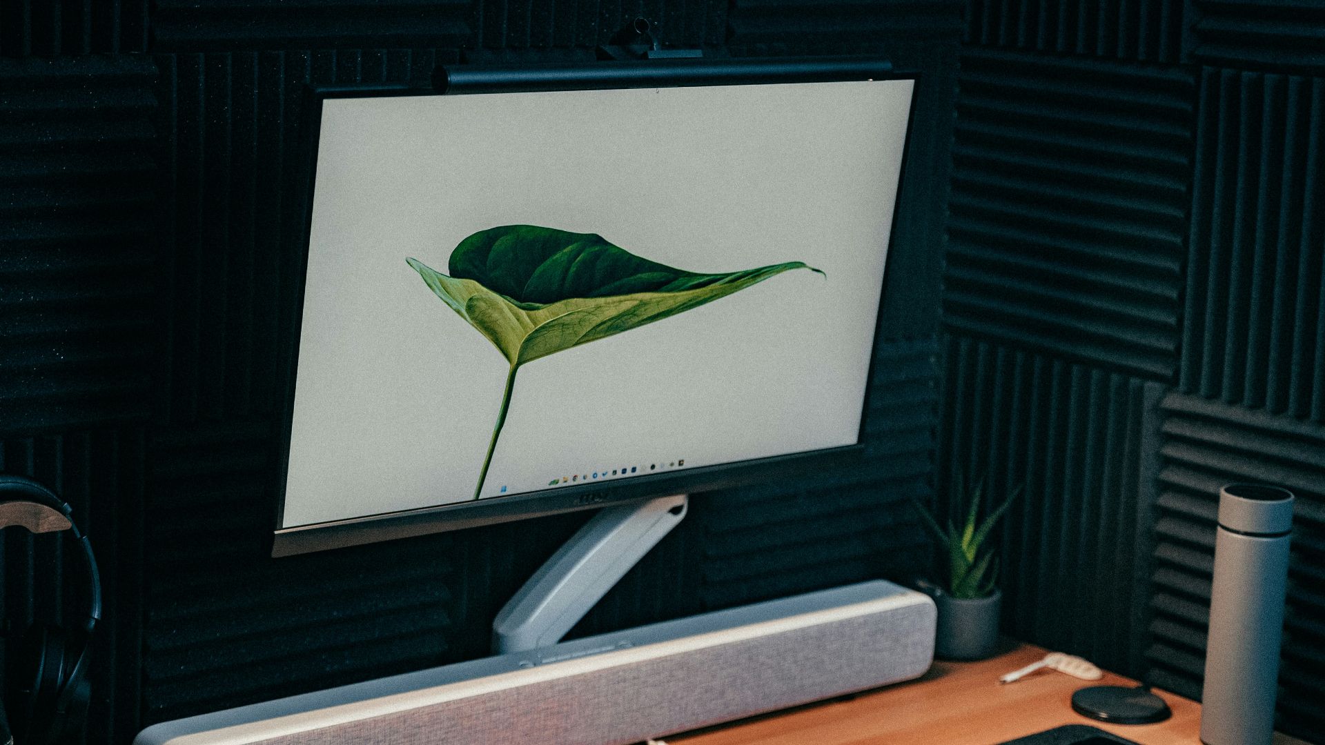 a computer monitor sitting on top of a wooden desk