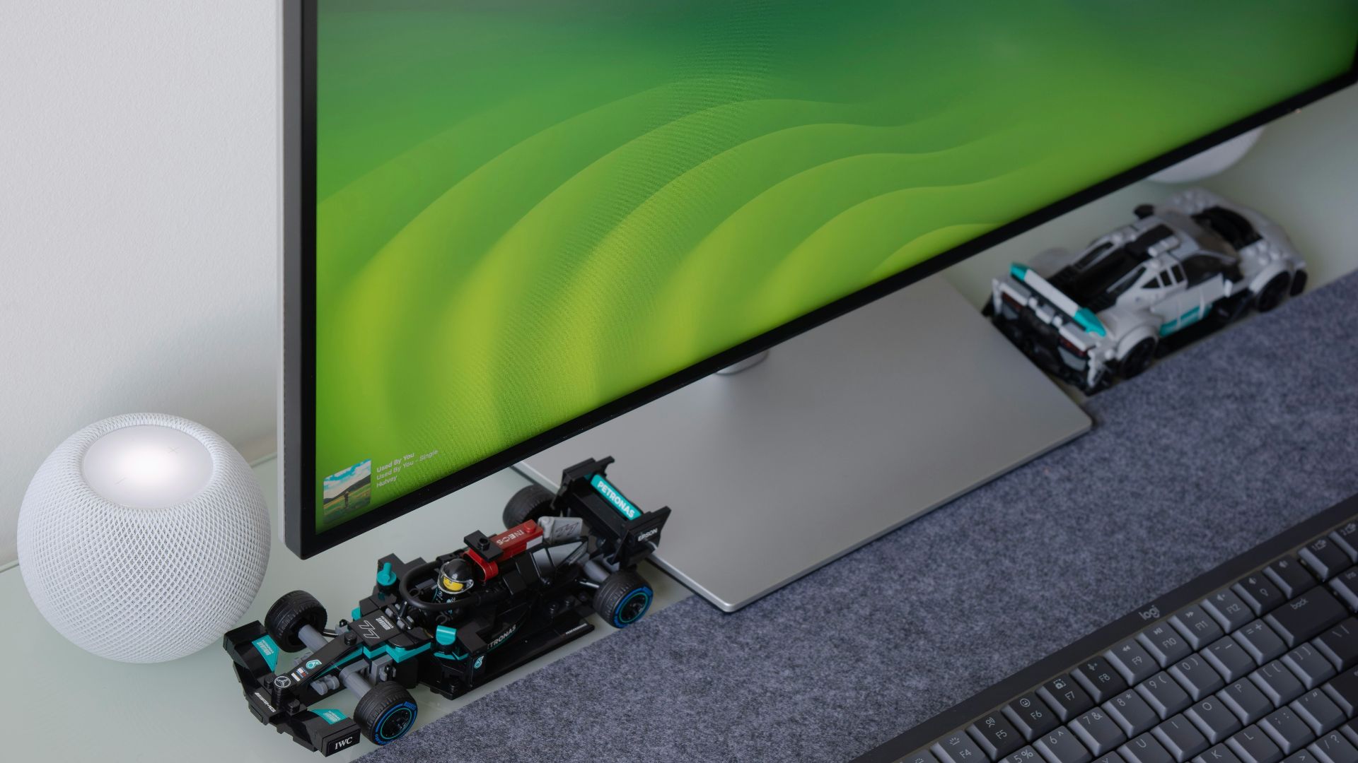 a computer monitor sitting on top of a desk next to a keyboard