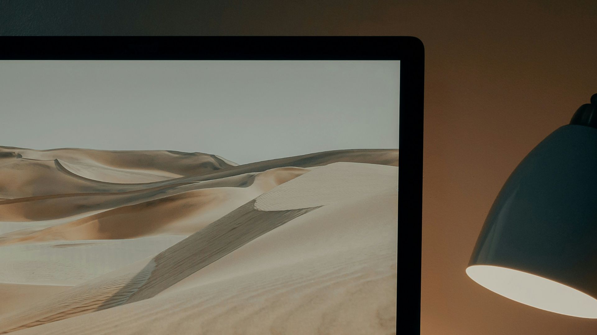 silver imac on brown wooden table