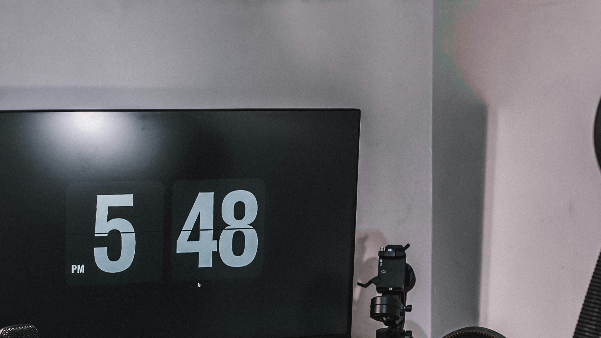 black flat screen computer monitor on black wooden desk