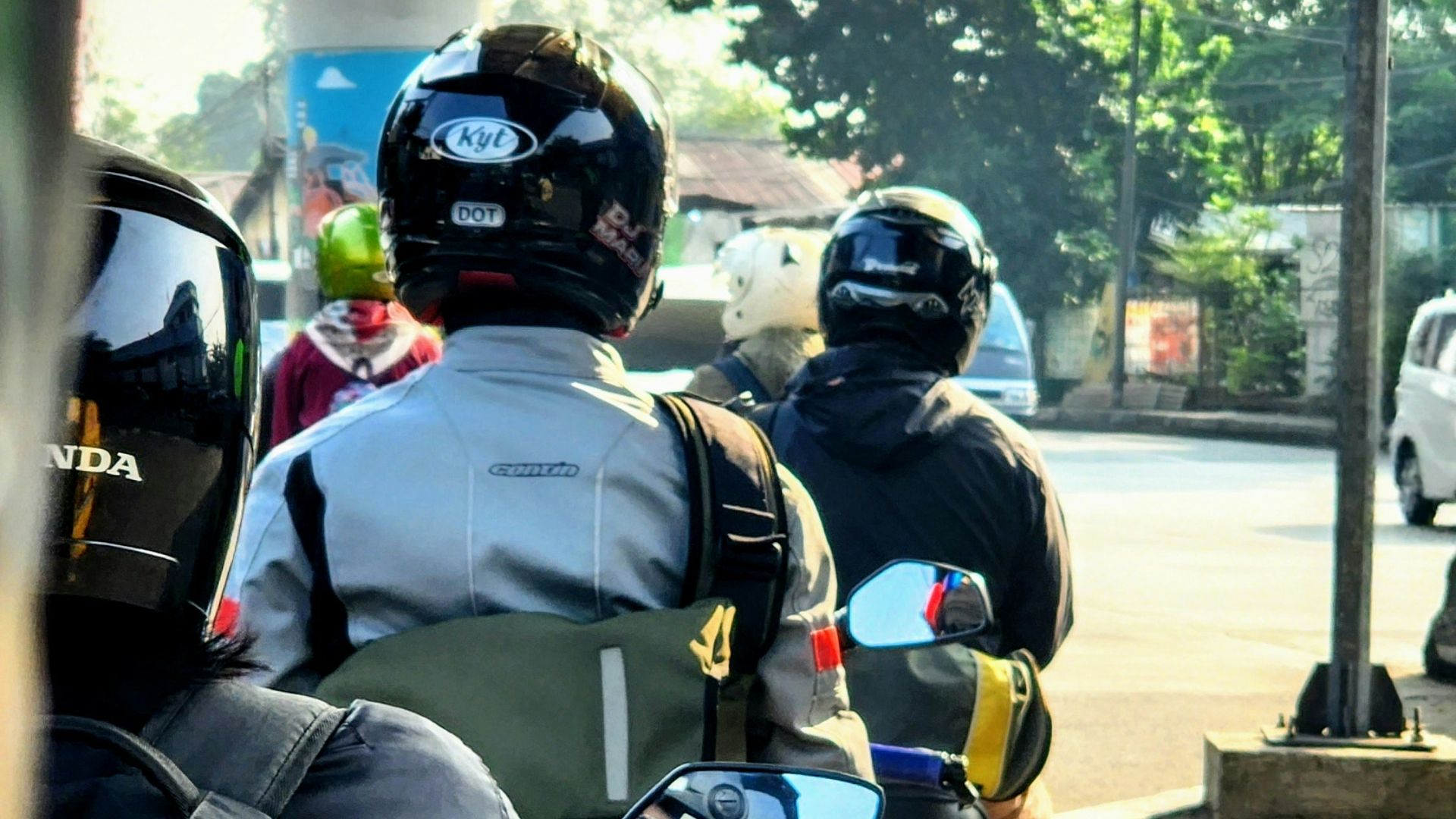 a group of people riding motorcycles down a street