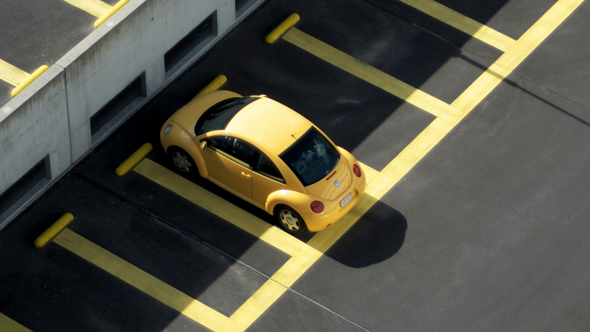 yellow coupe on parking lot at daytime