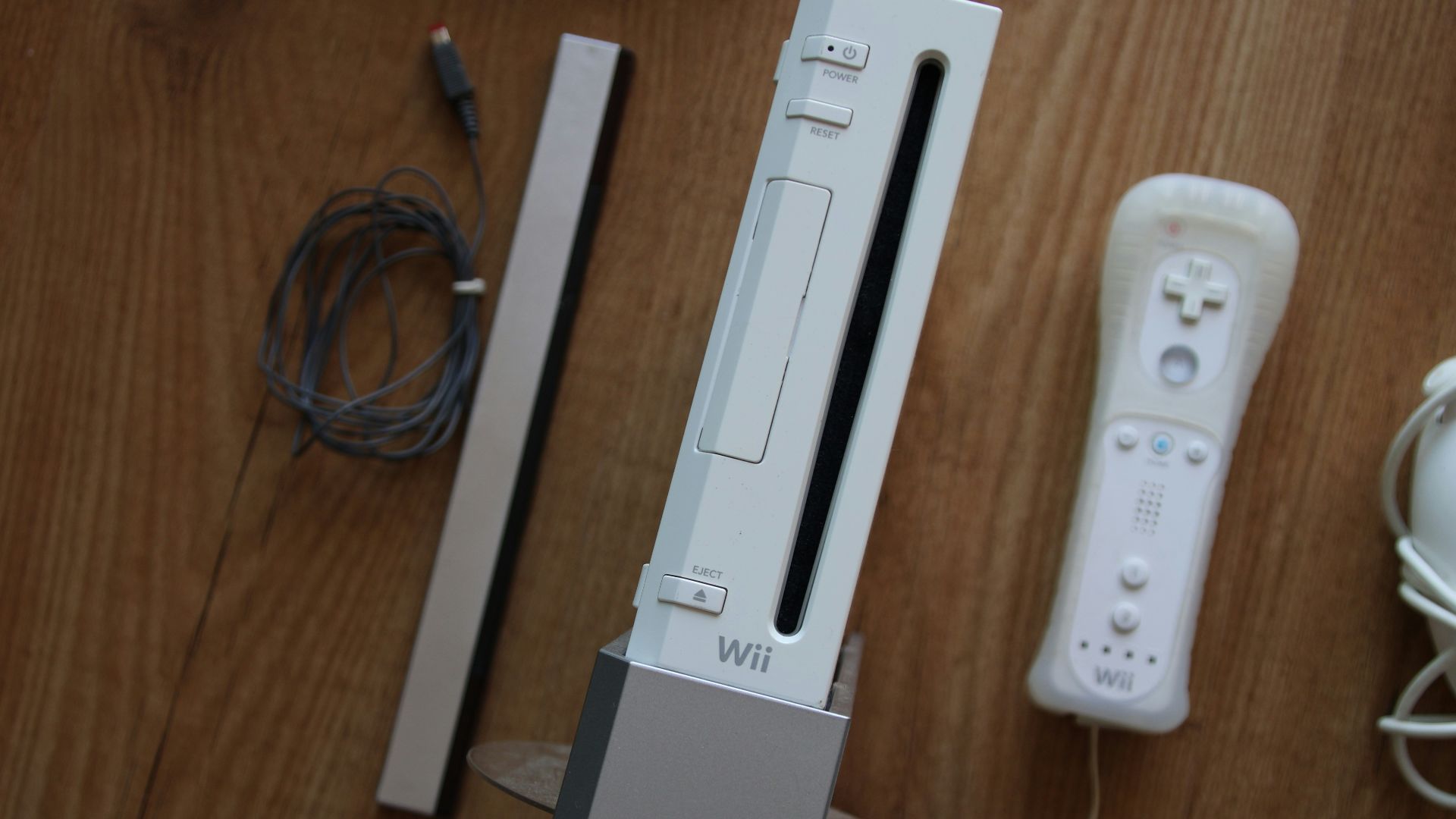 a nintendo wii game system sitting on top of a wooden table
