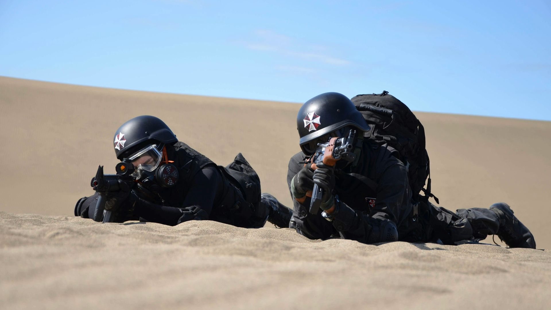 a couple of people that are laying in the sand