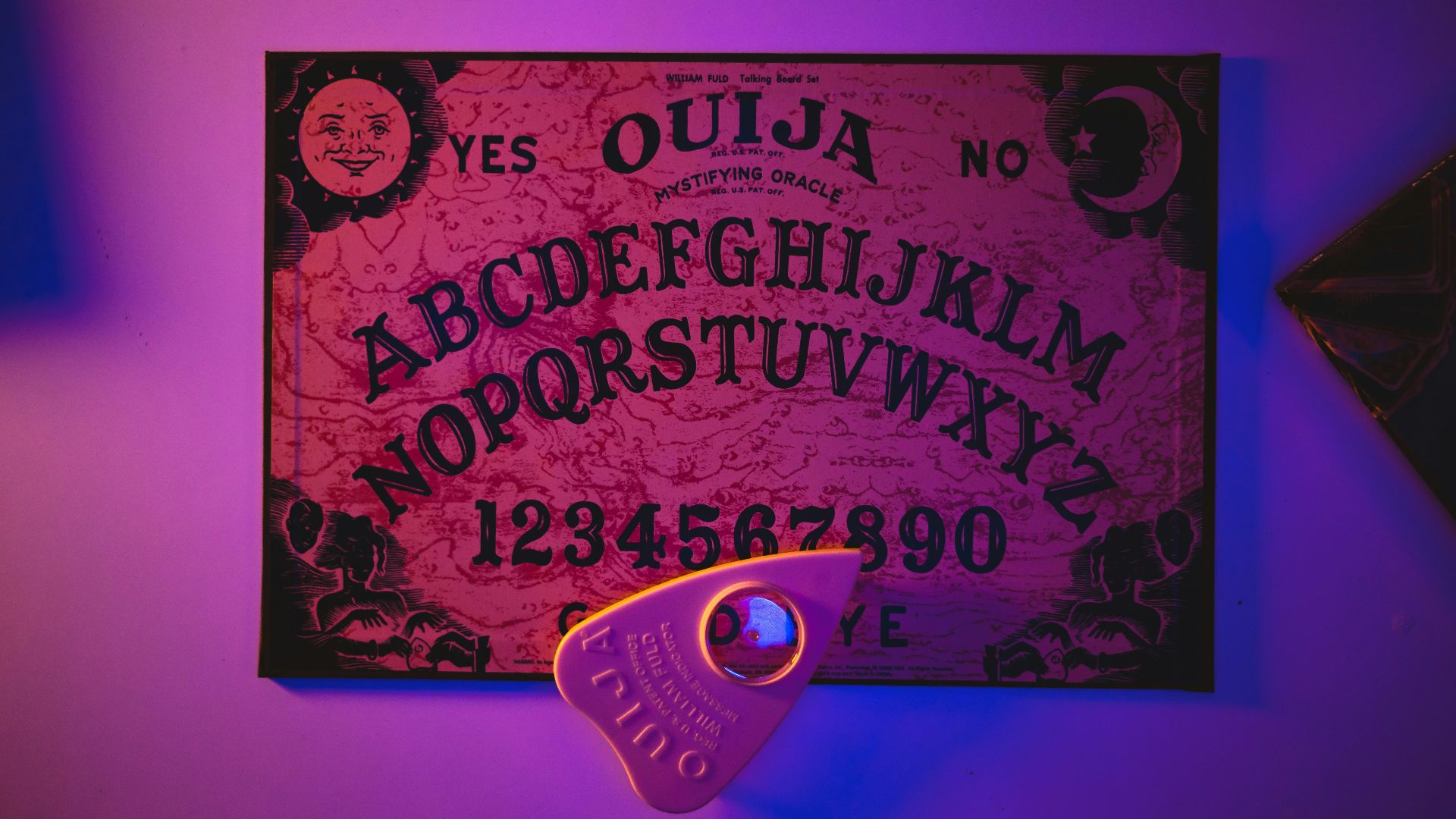 a purple lit room with a sign and a pair of scissors