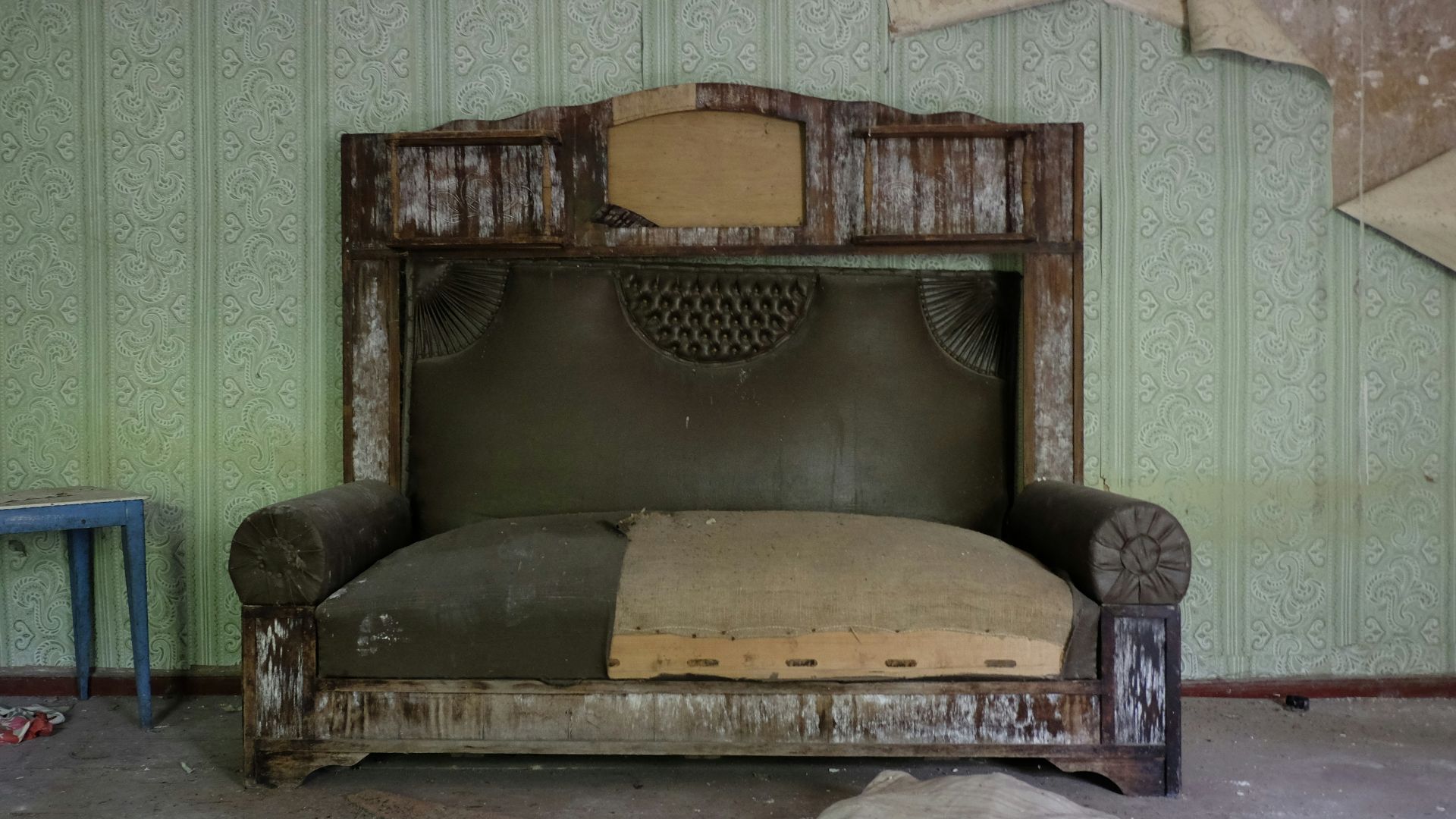 brown wooden framed brown padded armchair